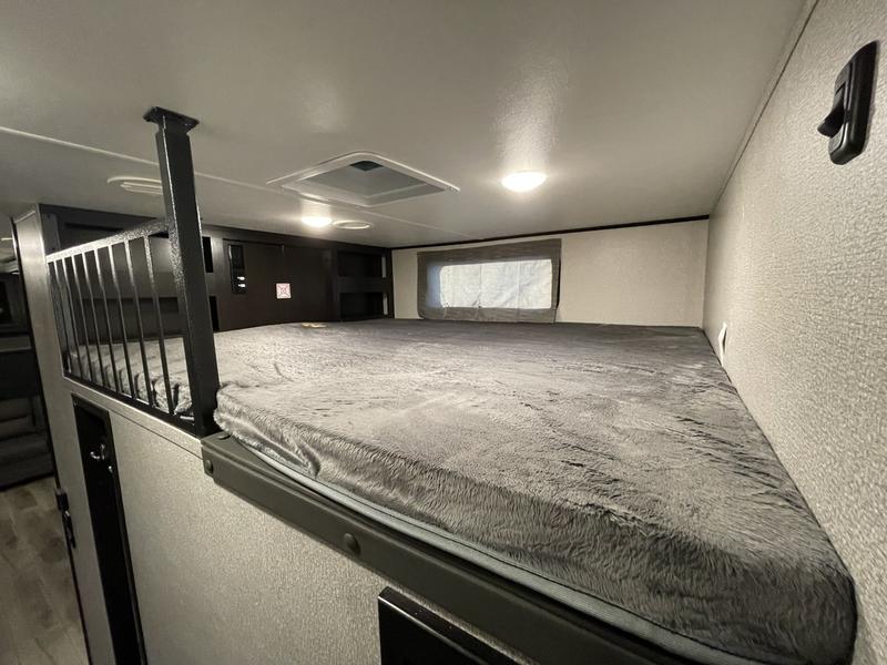 RV rental: Upper bunk bed with a plush gray mattress & safety railing. A compact, comfortable sleeping area inside.. Highland Ridge RV Open Range 2019