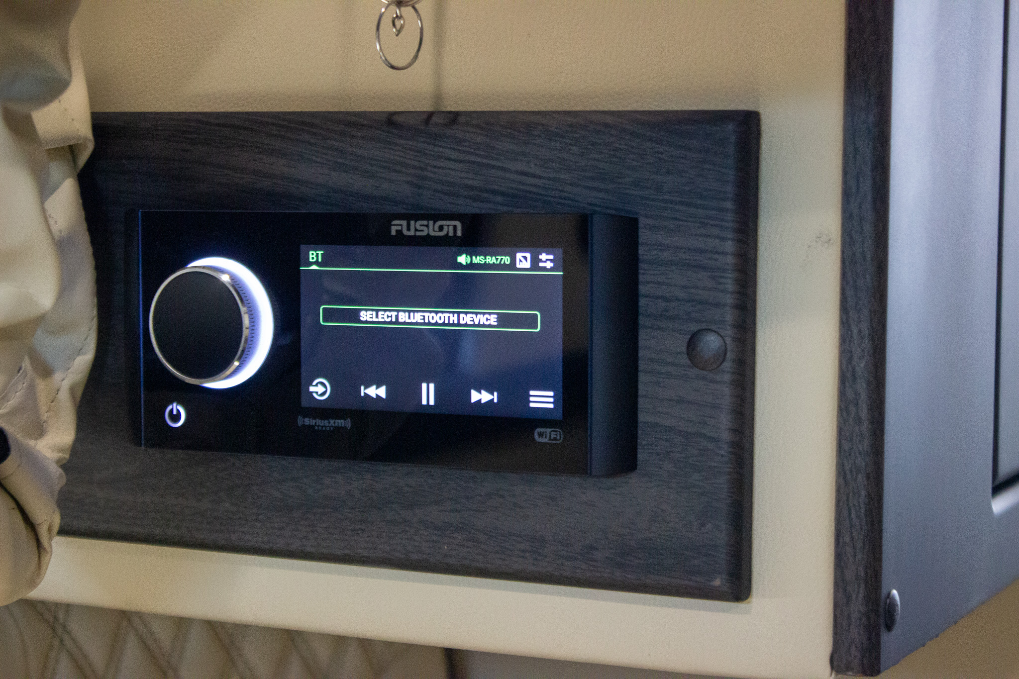 Modern Fusion audio system with an illuminated knob in an RV rental. The display shows "SELECT BLUETOOTH DEVICE" for audio.. Midwest Automotive Designs Other 2021