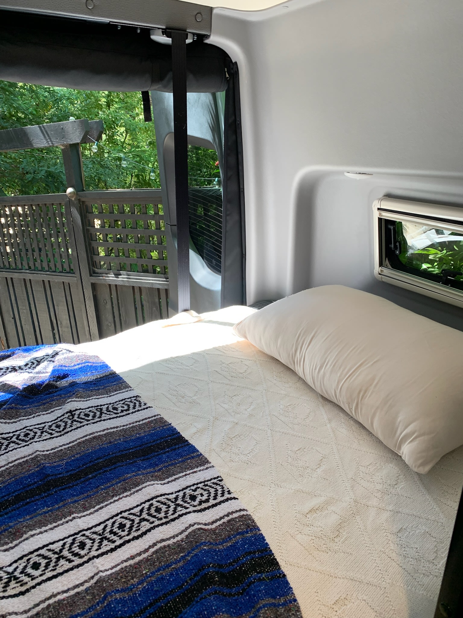 Relax in this cozy RV rental bed. Enjoy the outdoor view & sunlight from your mobile bedroom retreat.. Winnebago Revel 2022