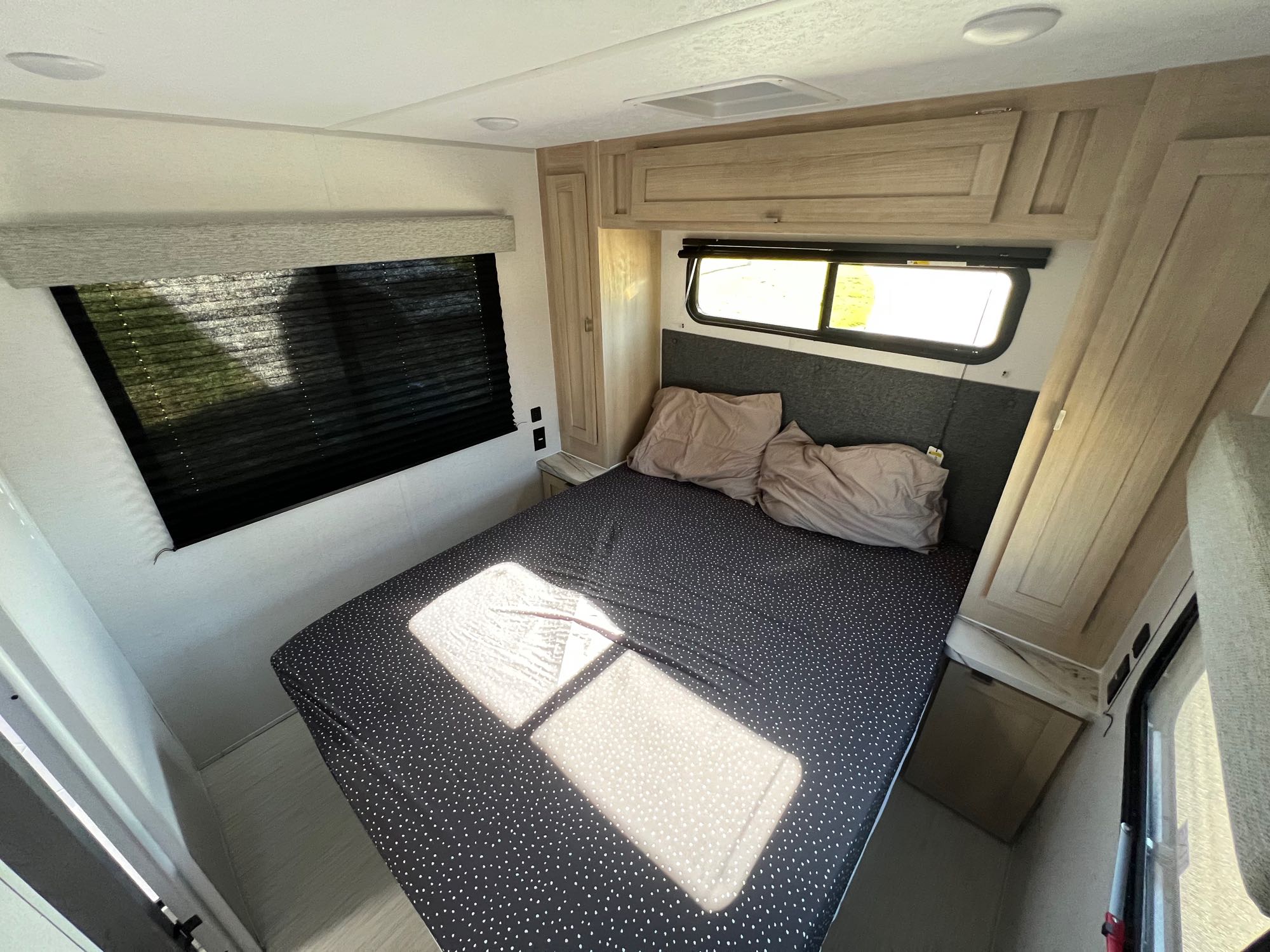 RV rental bedroom: comfy queen bed, built-in storage, bright windows.. Forest River Wildwood FSX Platinum 2023