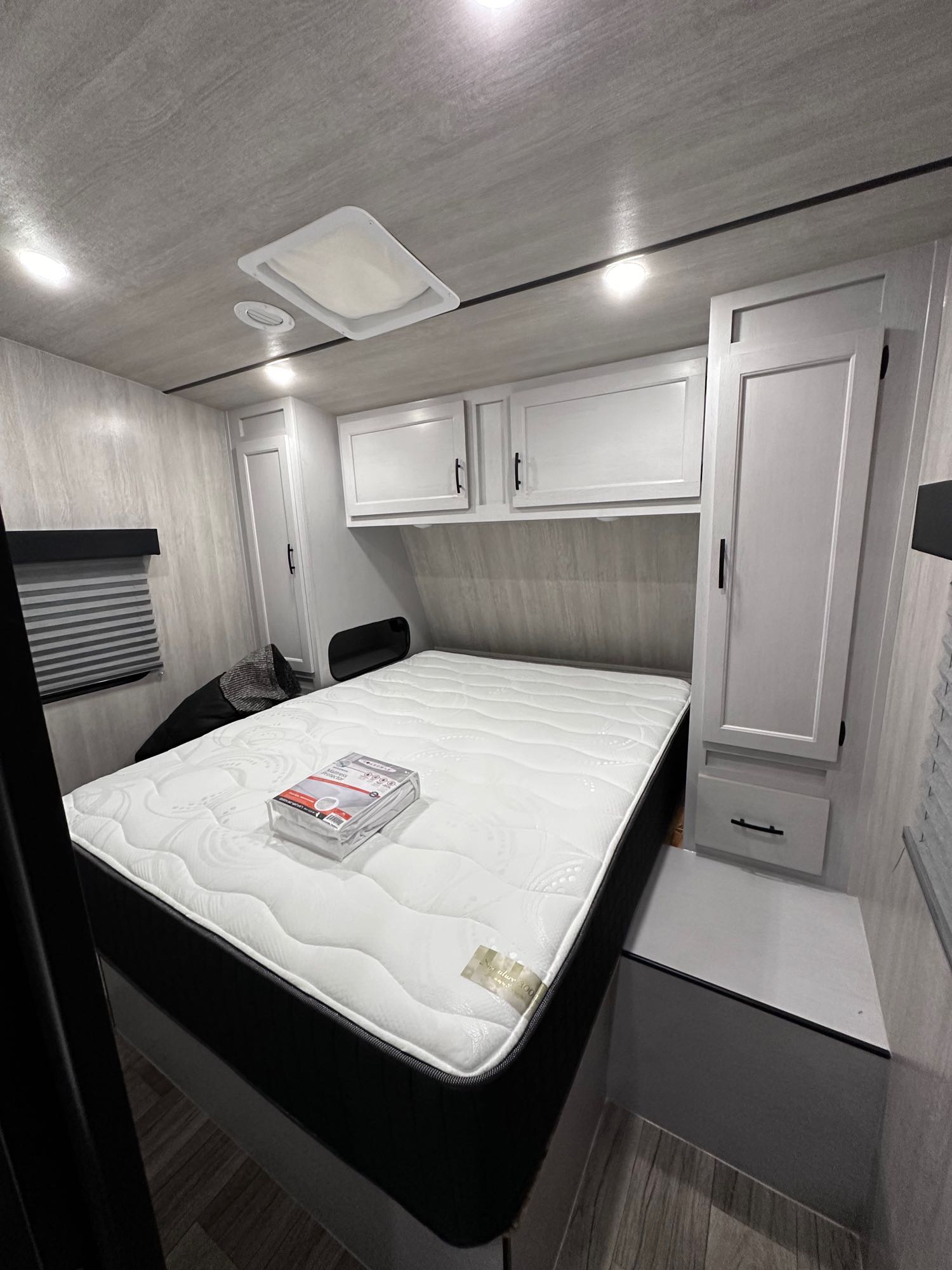 Modern RV rental bedroom showcasing a plush mattress, ample overhead storage, and a built-in wardrobe for your travels.. Genesis Supreme Rv Vortex Limited XL VFS275XL 2024