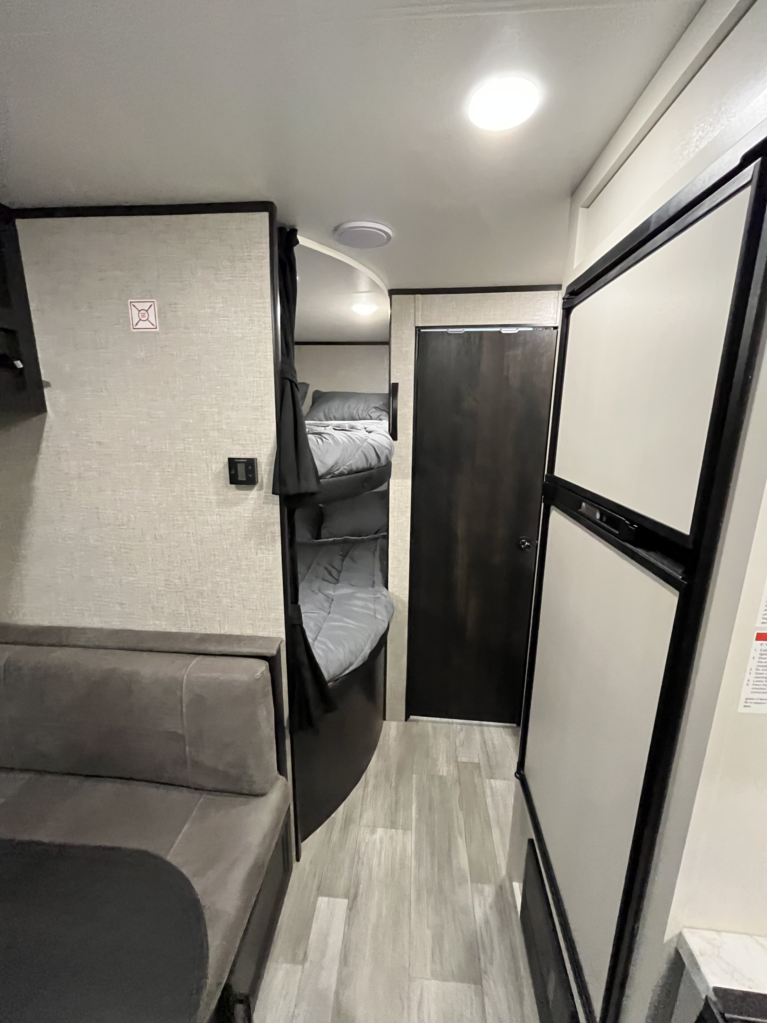 Cozy RV rental interior with bunk beds, sofa, and refrigerator; a smart layout for comfortable travel.. Jayco Jay Flight 2022