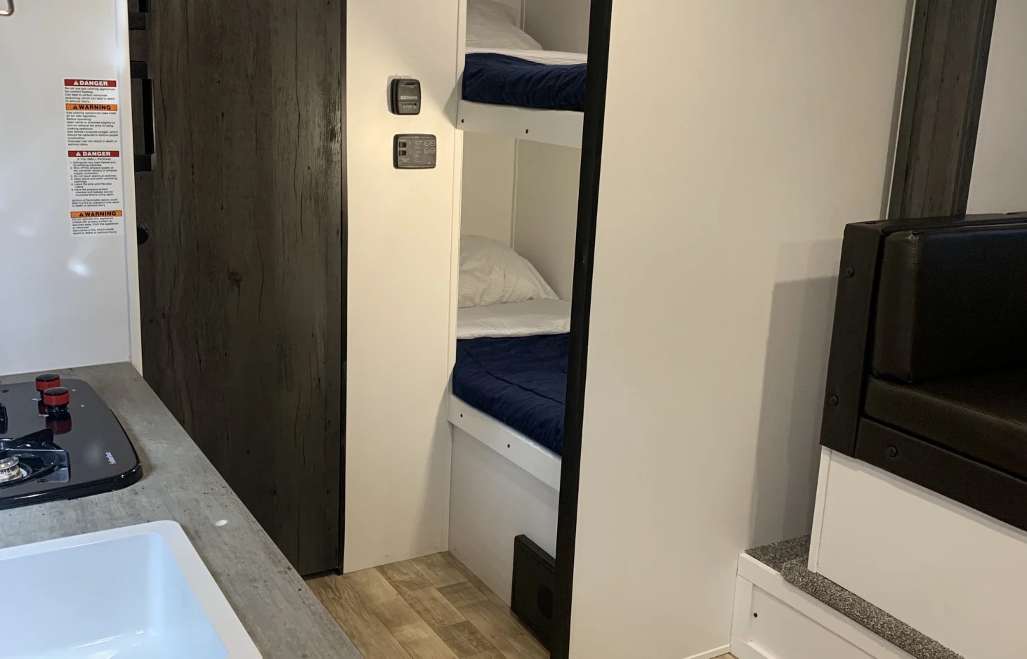 This RV rental offers a practical interior with a kitchen, bunk beds, and a cozy seating area for comfortable adventures.. Keystone RV Hideout 2021