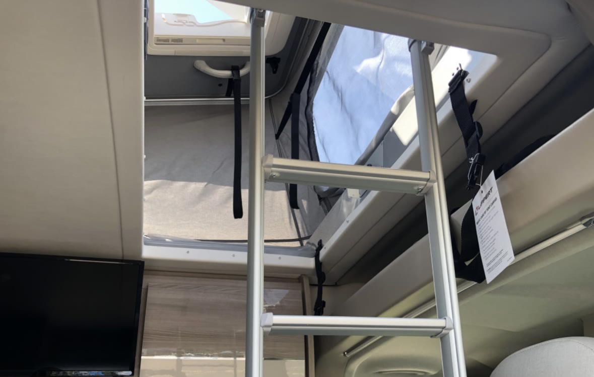 The second bed which also sleeps two is a pop out on the roof. The ladder attaches to the side for access. Thor Motor Coach Sequence 20-A 2022