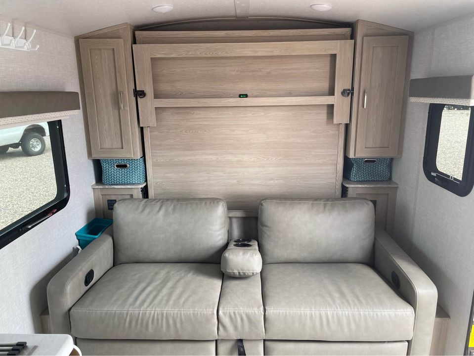 This RV rental's clever interior features a comfy sofa, built-in storage, and a stowable Murphy bed, perfect for compact living on the go.. Forest River Geo Pro 2021