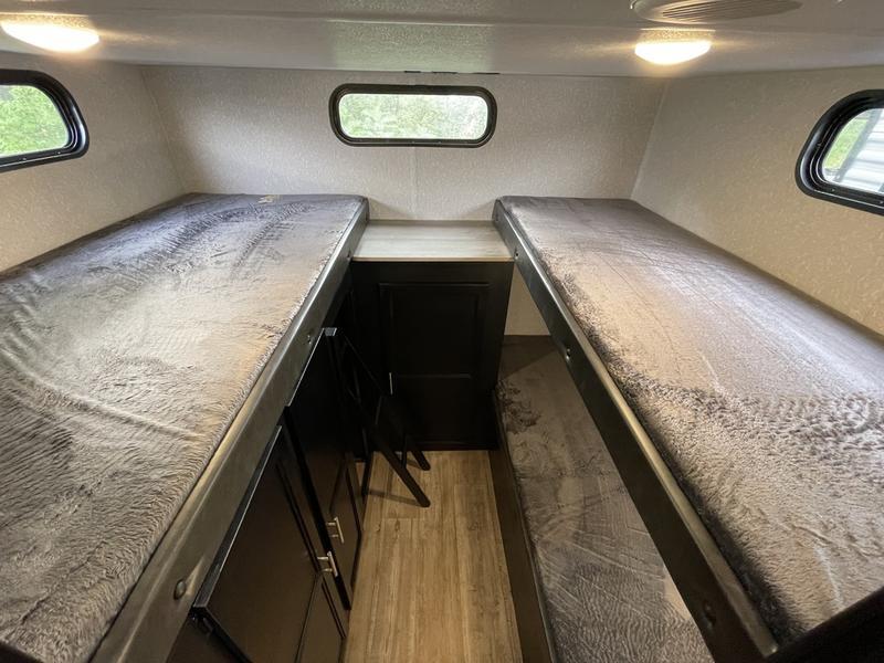 This RV rental features four cozy bunk beds, providing ample sleeping space with windows & storage for your travels.. Forest River Cherokee Grey Wolf 2021