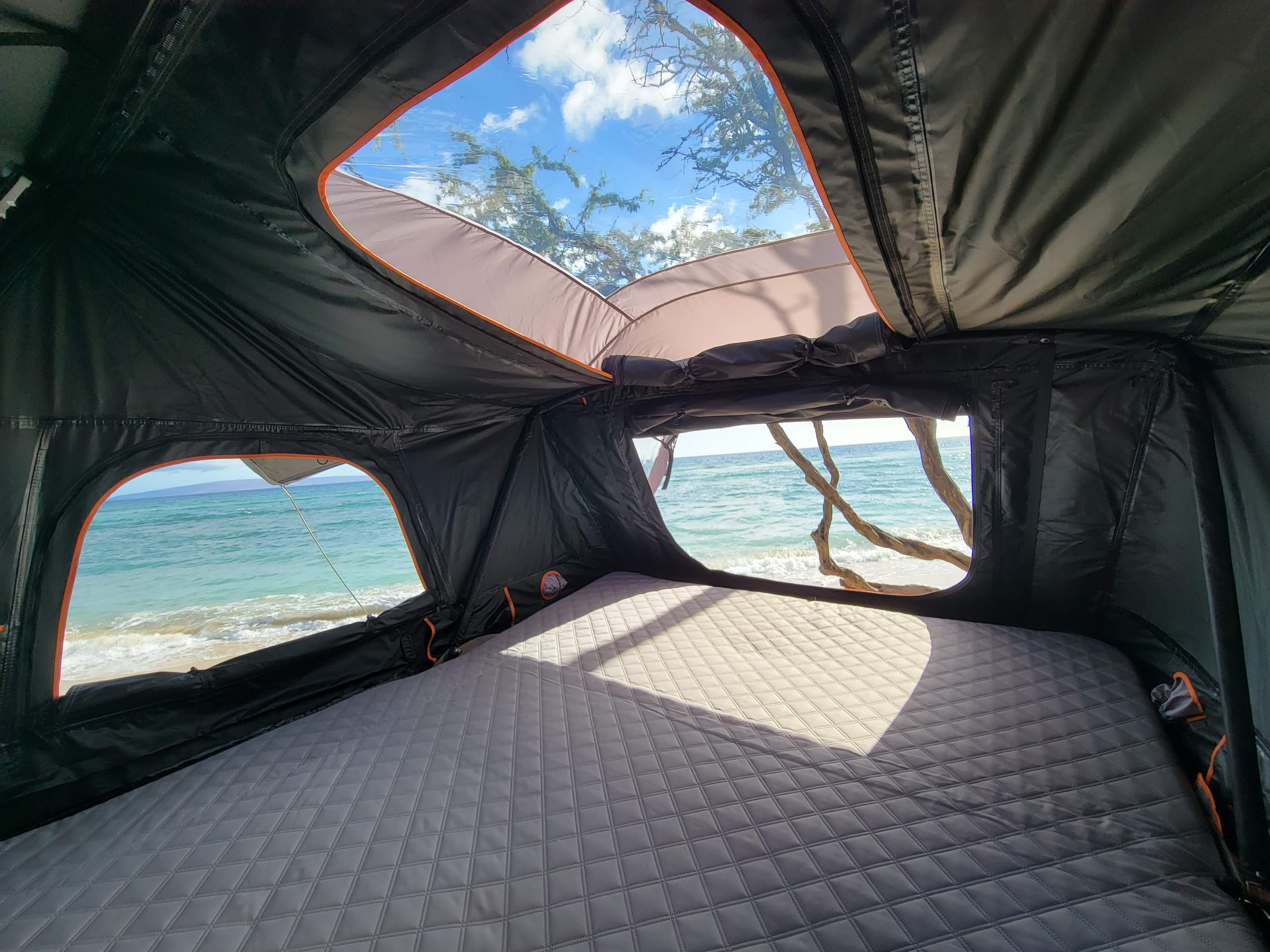 Experience an RV rental rooftop tent with stunning ocean views. Perfect for beach camping adventures from this unique accommodation.. Ford Bronco 2021
