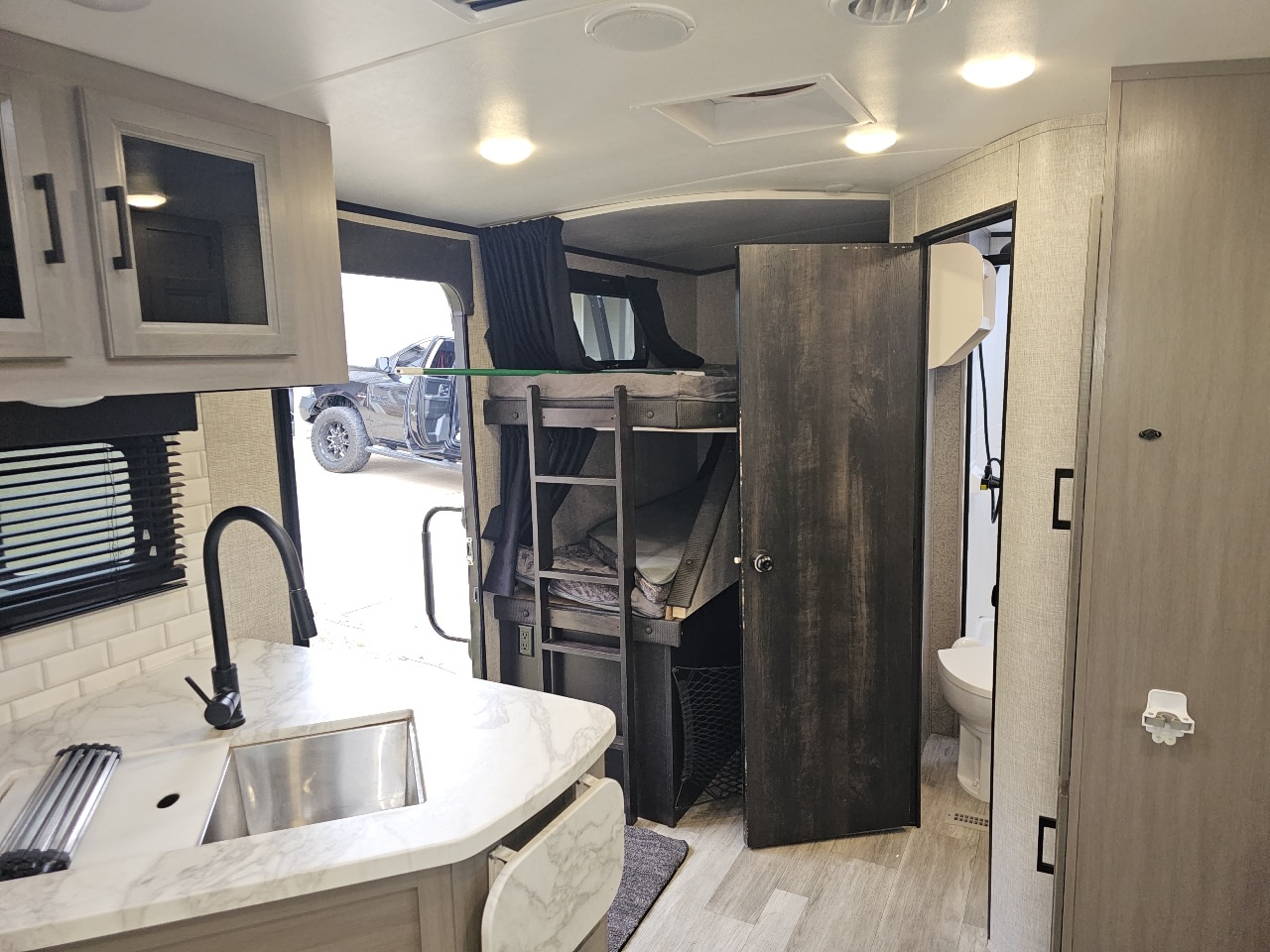Bathroom to the right, bunks in the back. Jayco White Hawk 2022