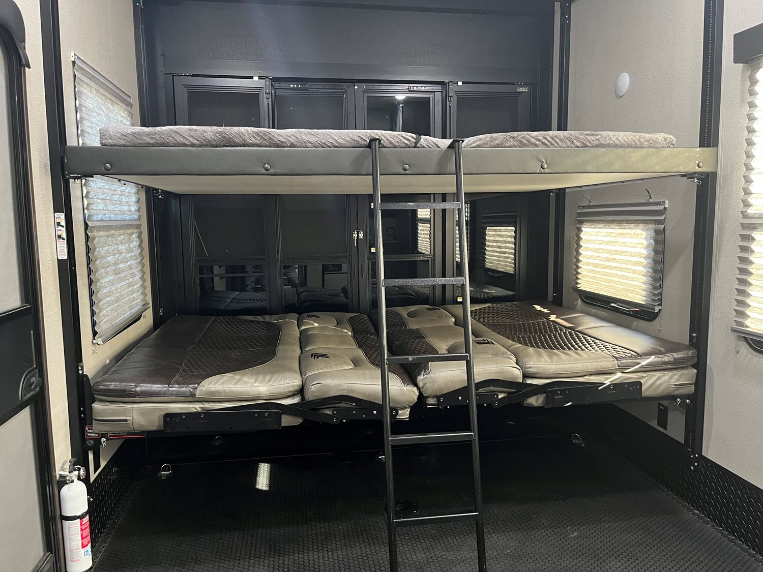 Inside this RV rental, you'll find a versatile sleeping area: an upper bunk bed and a lower convertible sofa/bed, accessed by a ladder.. Grand Design Momentum M-Class Toy Hauler 2022
