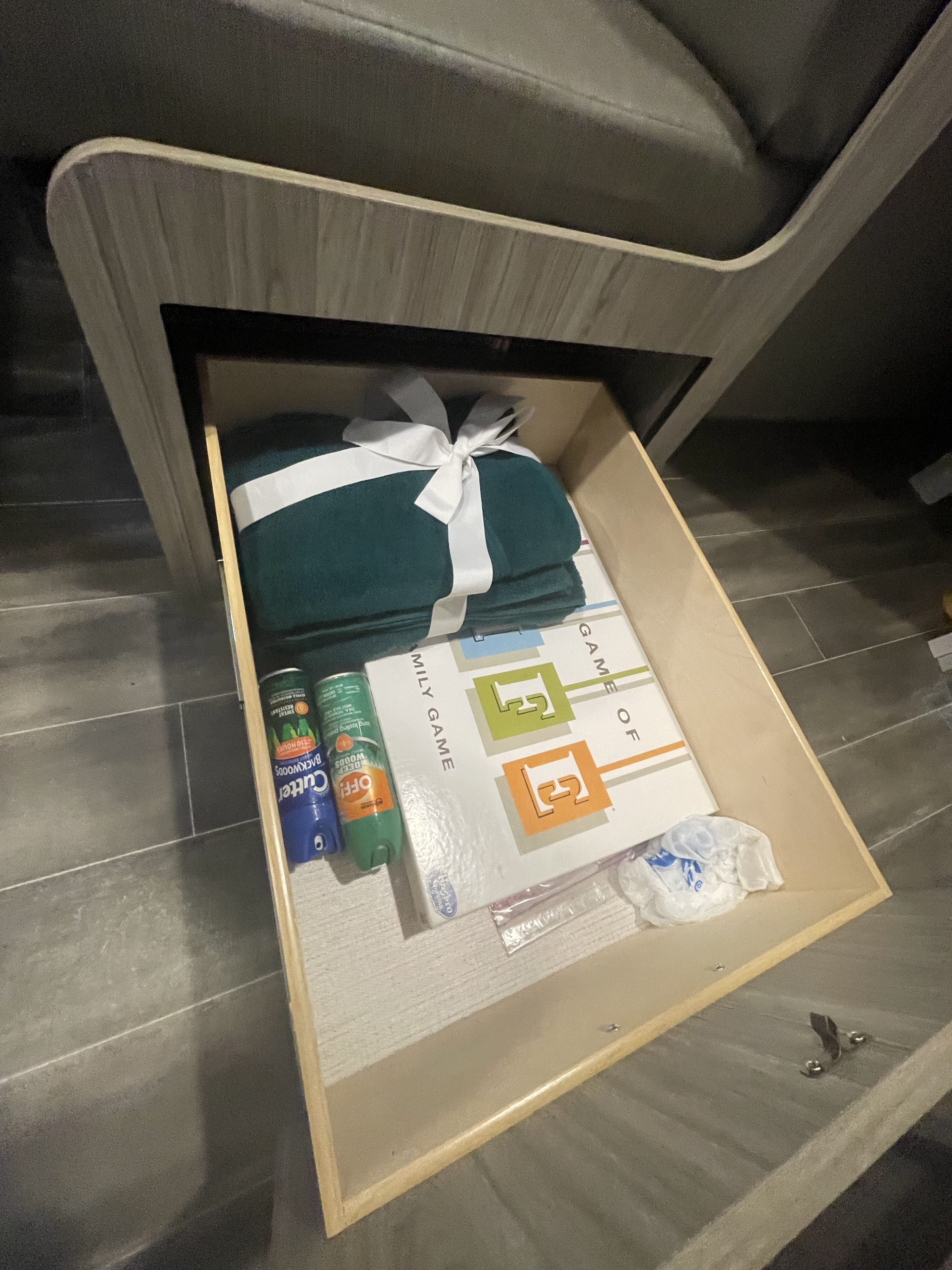This RV rental drawer holds a blanket, insect repellent, and board game for comfort & fun on the go. Perfect for camping!. Keystone RV Passport SL 2022