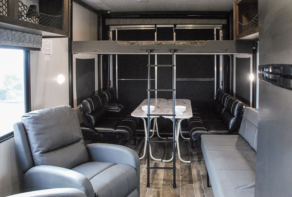 RV rental interior: a versatile living space with recliners, dining area, and upper bunk for flexible travel.. K-Z Manufacturing Sportster 2019