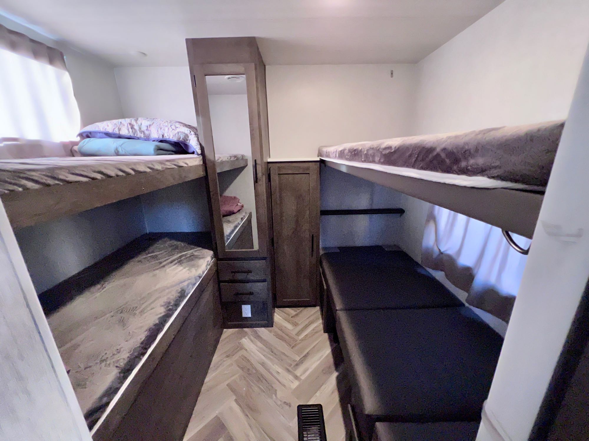 RV rental: Bright bunkhouse featuring two sets of beds, storage cabinets with a mirror, and herringbone flooring.. Forest River T30qbss 2022