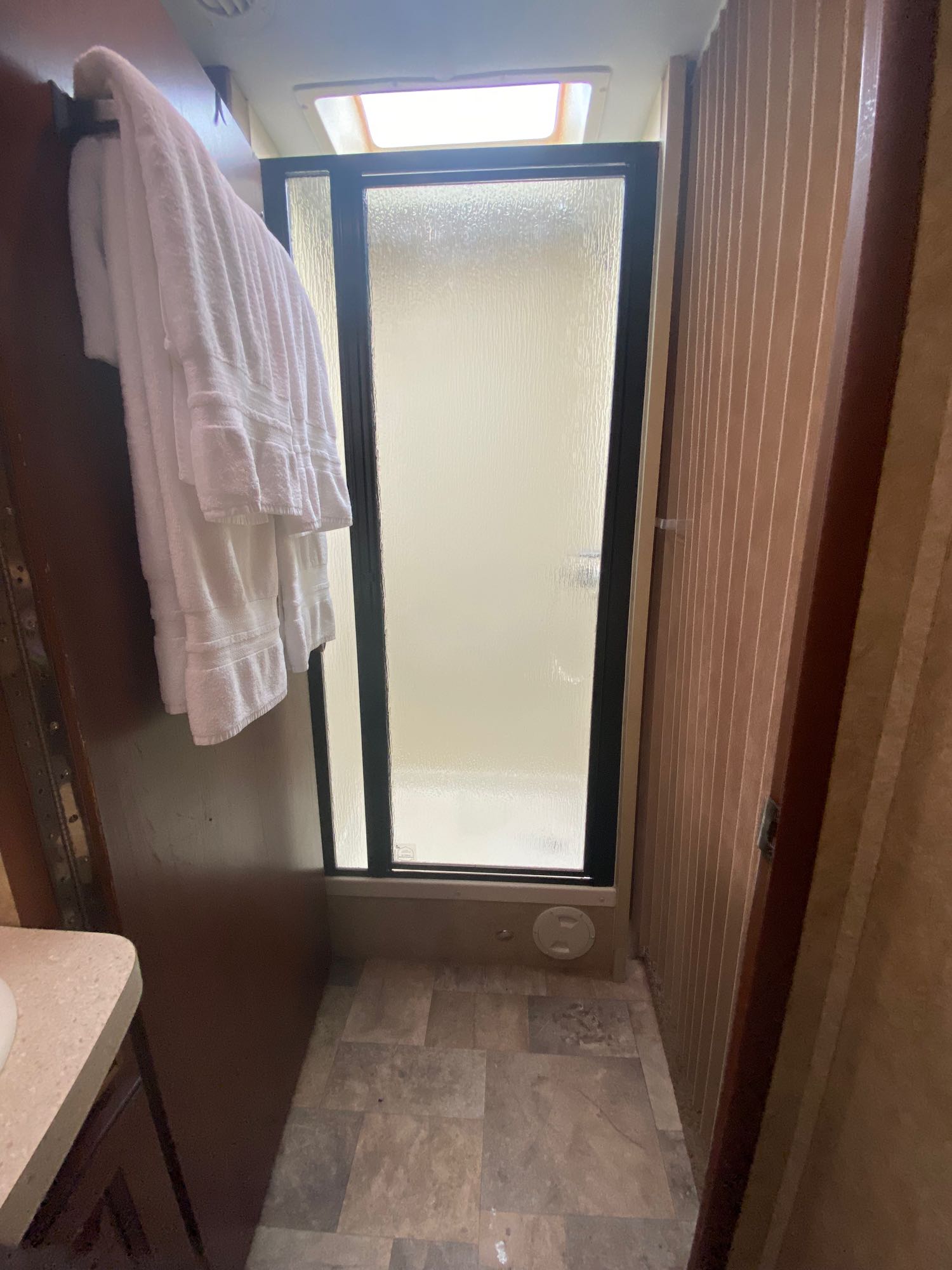 The bathroom door latches open and a closed curtain on the other side creates an open and private place to have your refreshing shower routine. . Forest River Lexington 283gts 2013