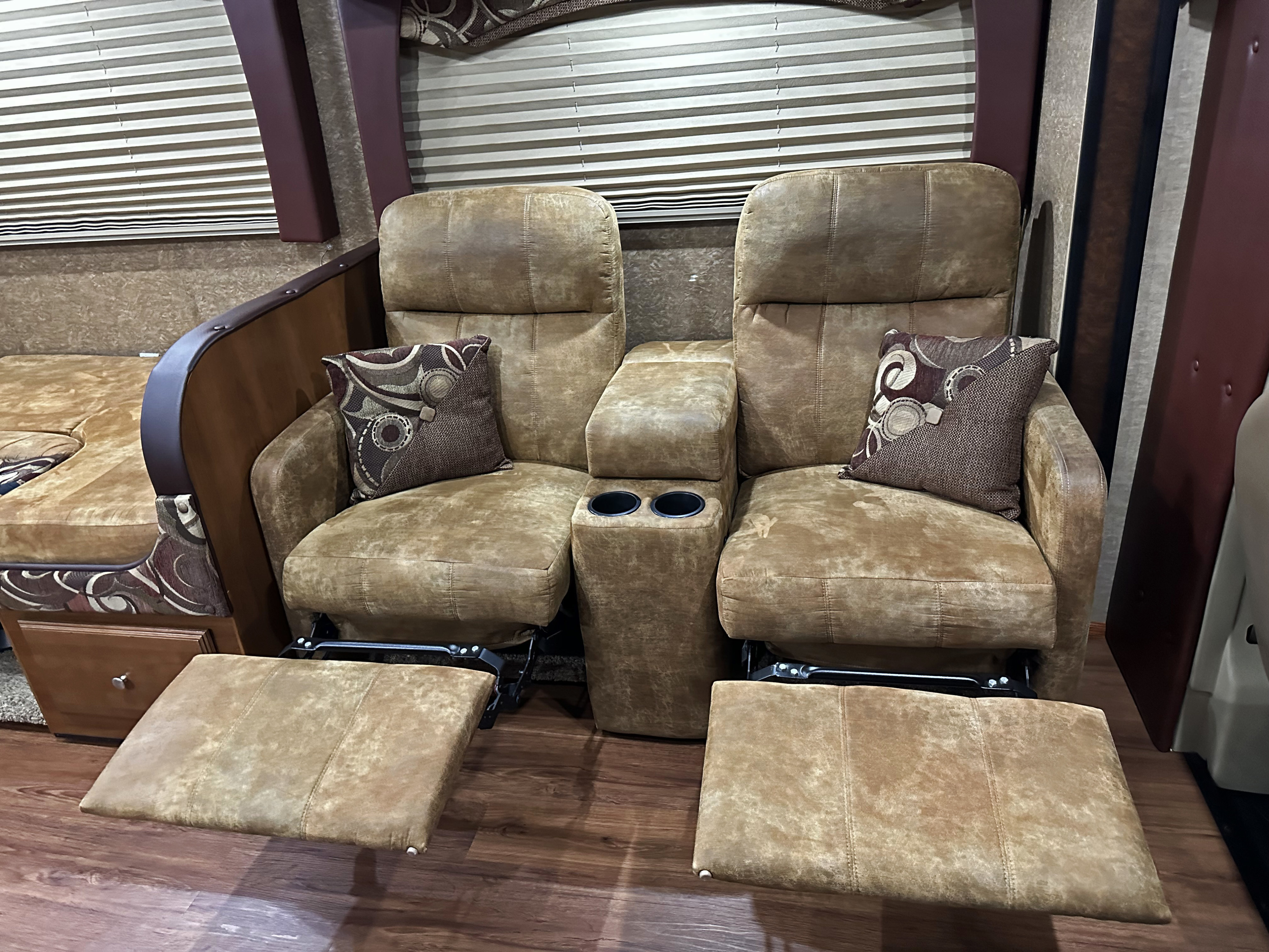 Plush reclining RV chairs with footrests & cup holders, ideal for a comfortable rv rental experience.. Forest River Coachmen Leprechaun 2015