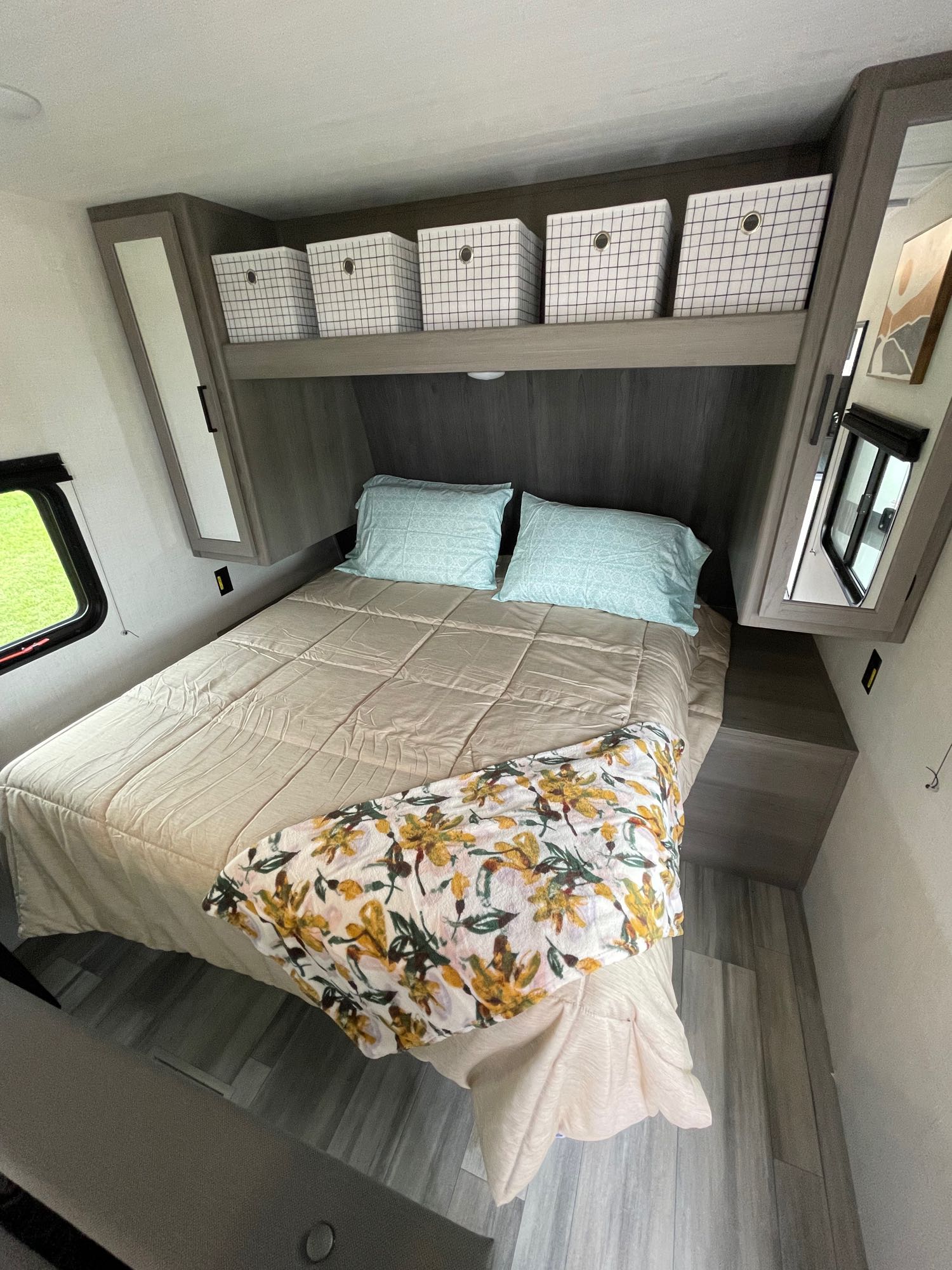 Experience comfort in this RV rental bedroom, featuring a cozy bed, ample storage, and natural light from the window.. Keystone Hideout 240BH 2024