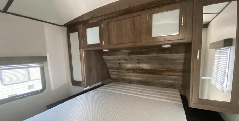 Bedroom with plenty of storage space! Outlets conveniently placed as well. 60x80 FULL size queen bed!. Keystone RV Passport Grand Touring 2019
