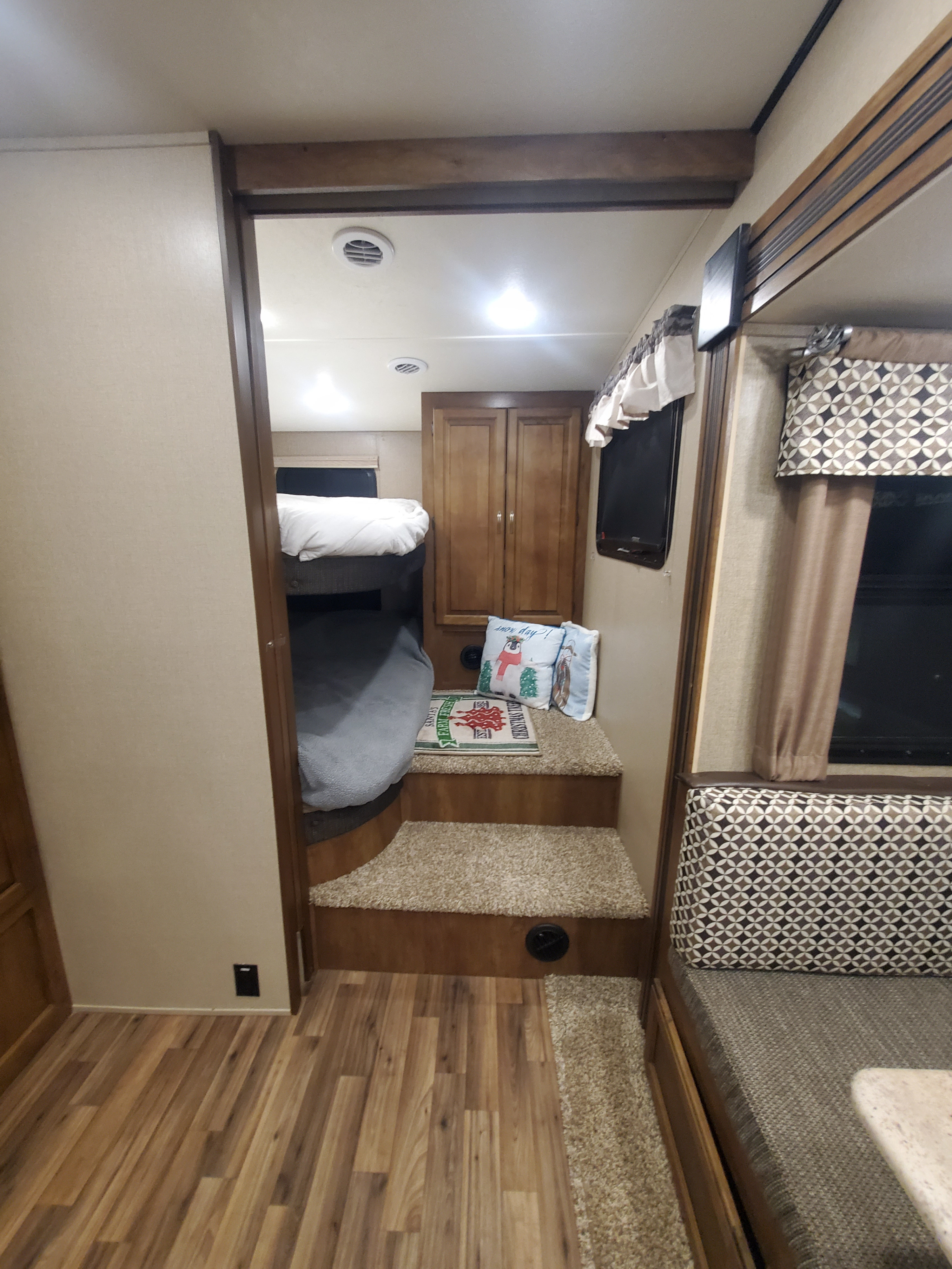 RV rental: interior view with bunk beds, carpeted steps, cabinet, and partial dinette. Functional and inviting layout.. Coachman Chapperal 2018