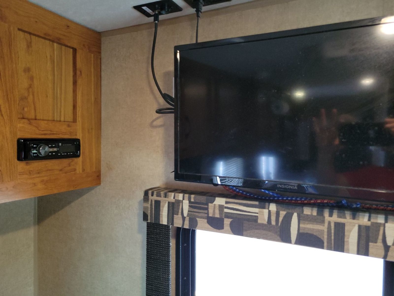 RV rental interior featuring a flat-screen TV, ceiling-mounted connections, and a built-in stereo in a wooden cabinet.. Starcraft AR-One Maxx 2015