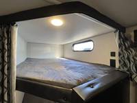 RV rental: Spacious upper bunk bed featuring a comfy mattress, window, ceiling light, and privacy curtains for a great night's sleep.. Forest River Cherokee 2022