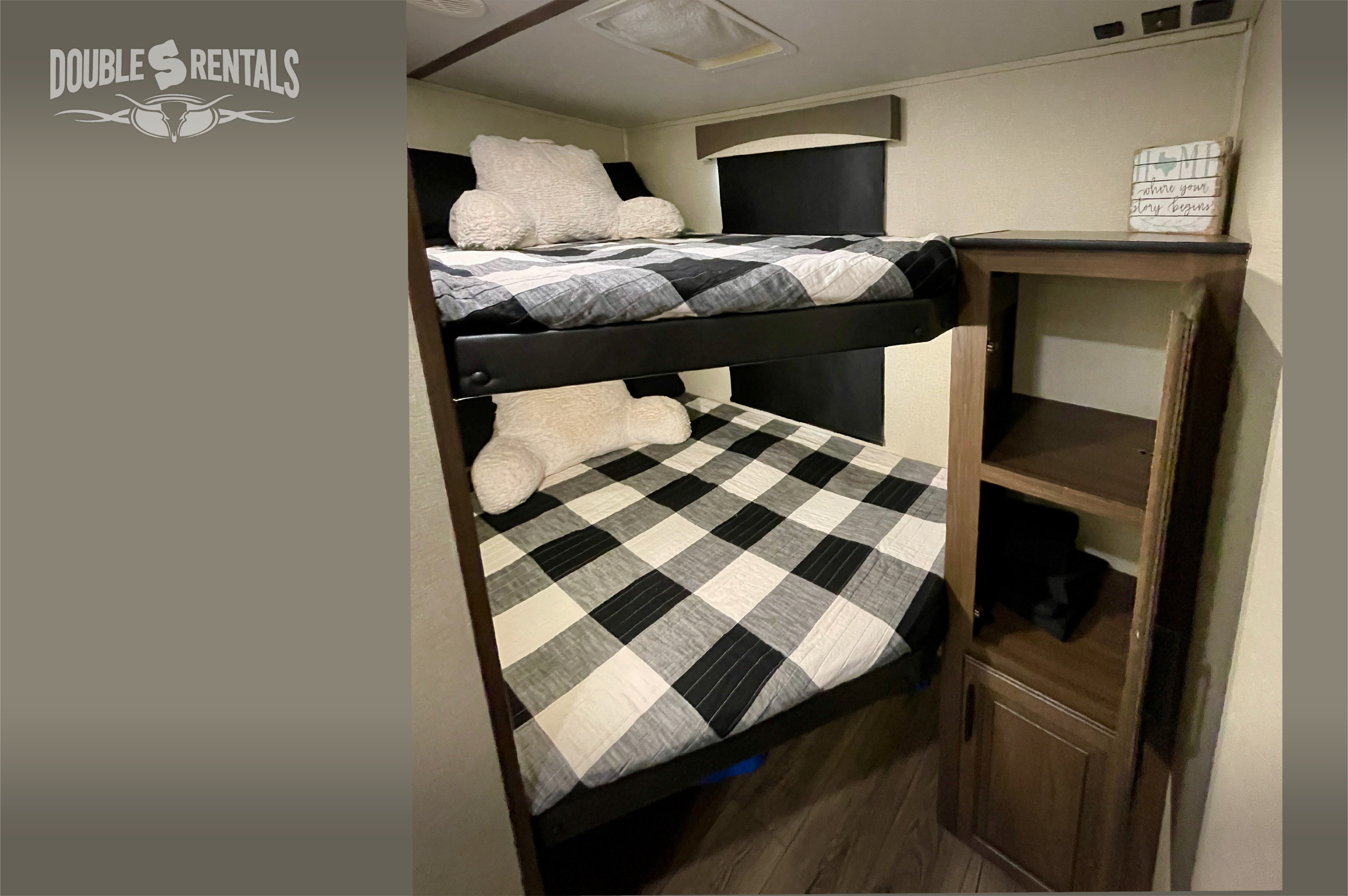 Cozy RV rental features comfy black and white plaid bunk beds and a convenient storage cabinet, ideal for family travel.. Prime Time Crusader Lite 2020