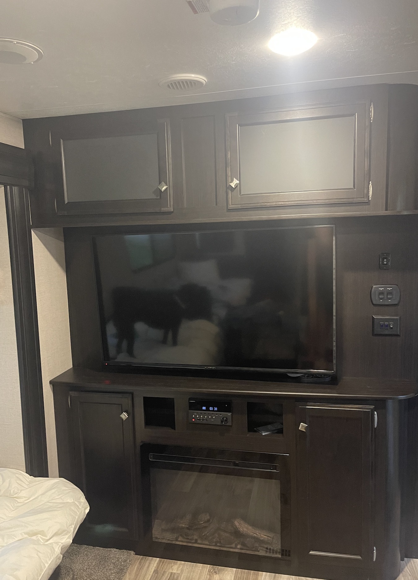 RV rental: Dark wood interior with TV, fireplace, and controls. Features include storage cabinetry and a pet reflection.. Sport trek 322vrl 2020