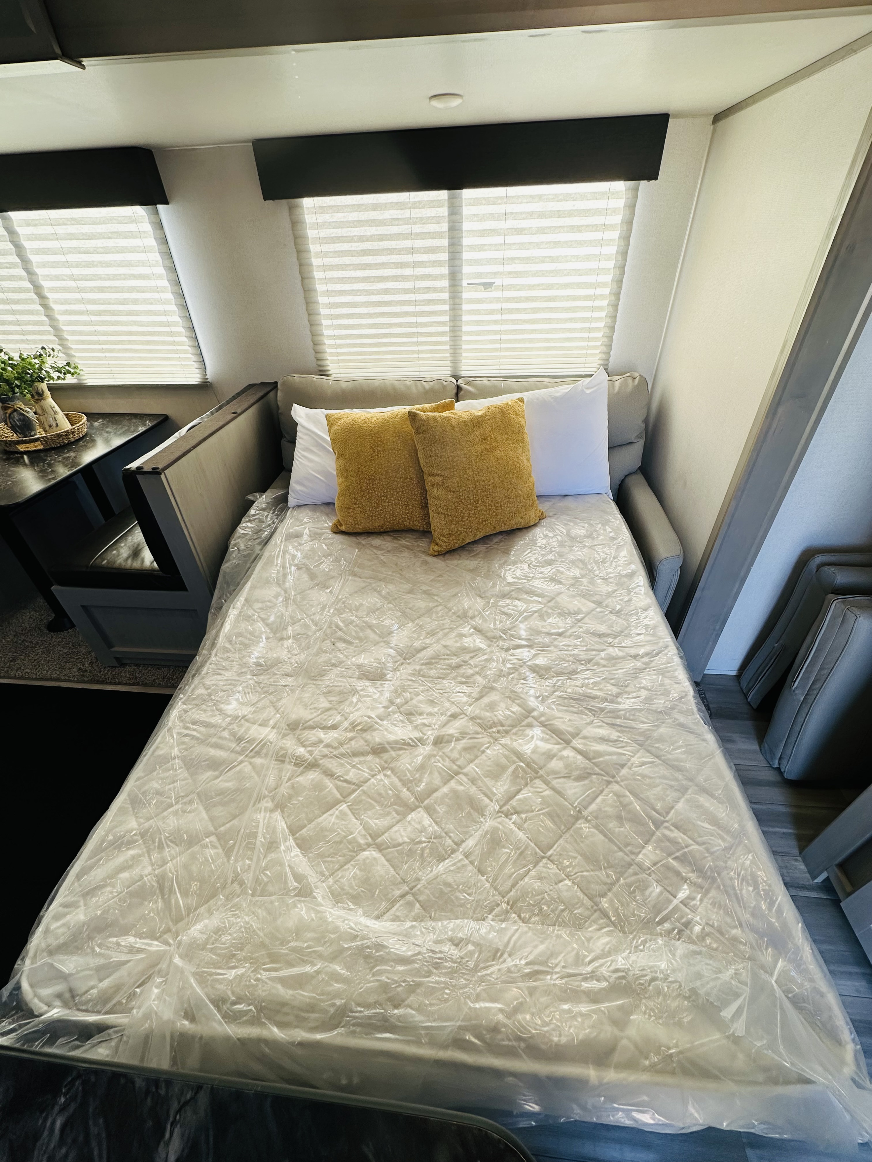 RV rental with fresh, wrapped convertible bed & cozy dinette setup.. Forest River Tracer LE 2021