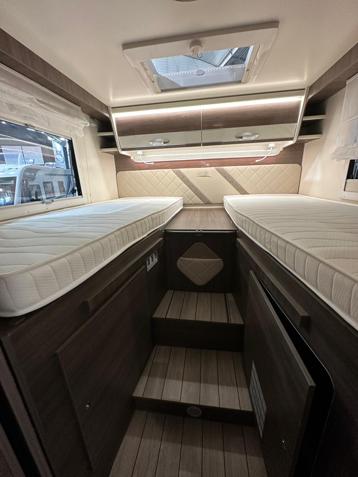 Comfortable RV rental bedroom with twin beds, overhead storage, and steps for easy access. Ideal for your next motorhome adventure.. McLouis Yearling 83 2024