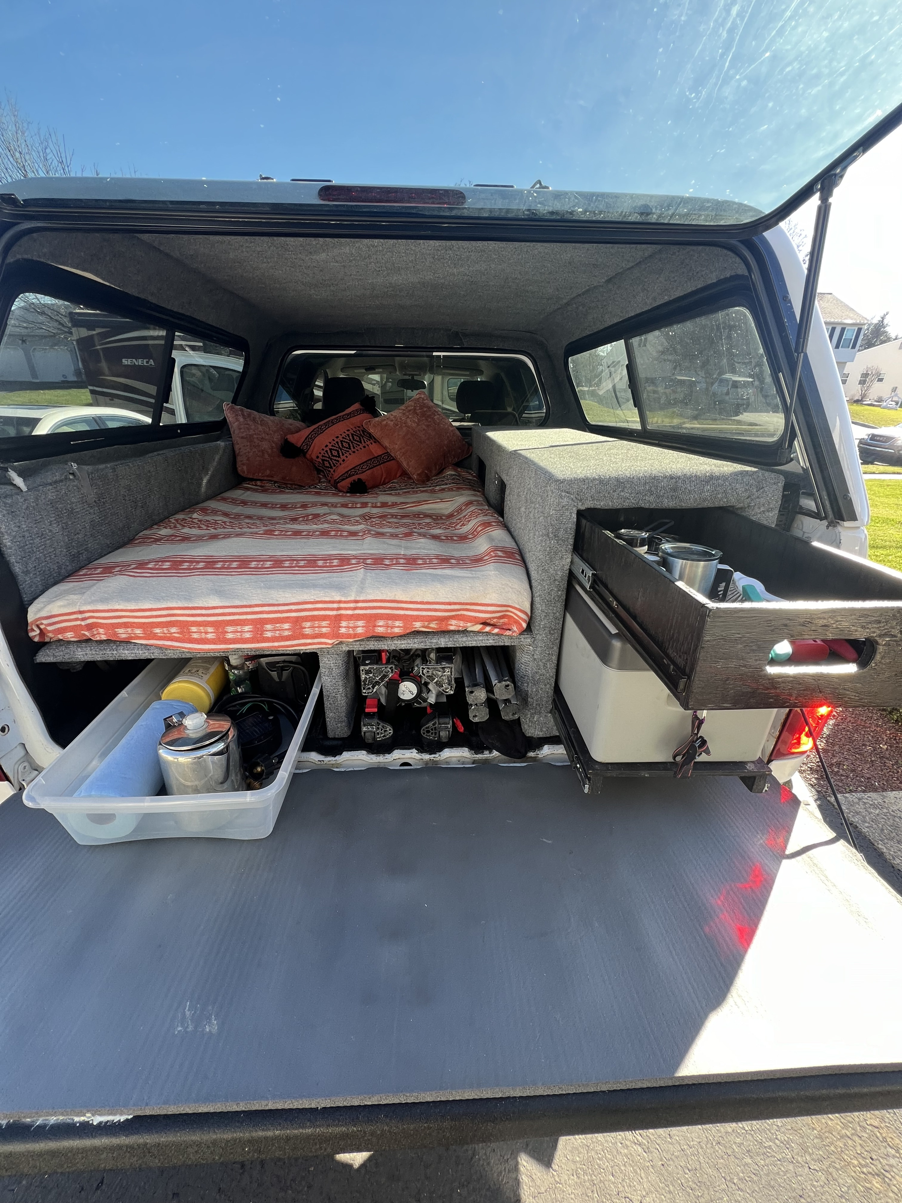 A cozy truck bed camper for adventure, featuring a bed, organized storage, and a pull-out kitchen drawer. Perfect for an RV rental trip!. Chevrolet Silverado 1500 2009