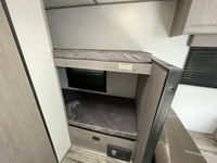 RV rental interior: cozy bunk beds with mattresses offer comfortable sleeping. Perfect for family RV adventures!. Coleman Lantern 17B 2024