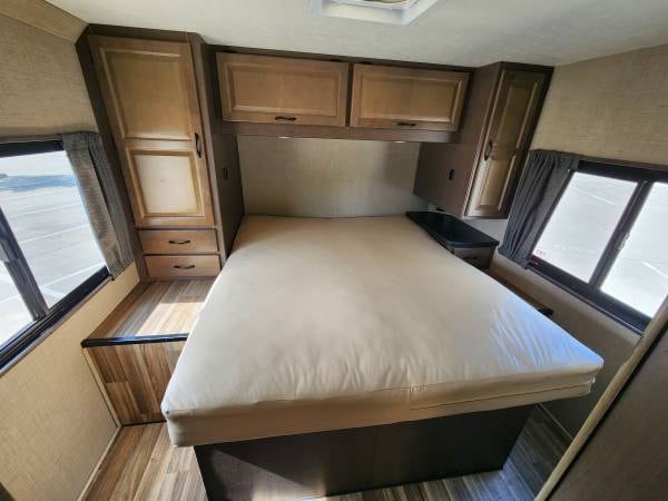 Spacious RV rental bedroom with comfortable bed, ample storage cabinets, and large windows. Great for travel.. Thor Majestic 2019