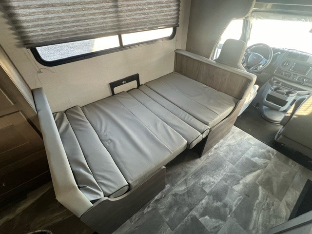 RV rental: Spacious interior featuring a gray convertible sofa bed & front driver's area.. Gulf Stream Conquest 6237LE 2024
