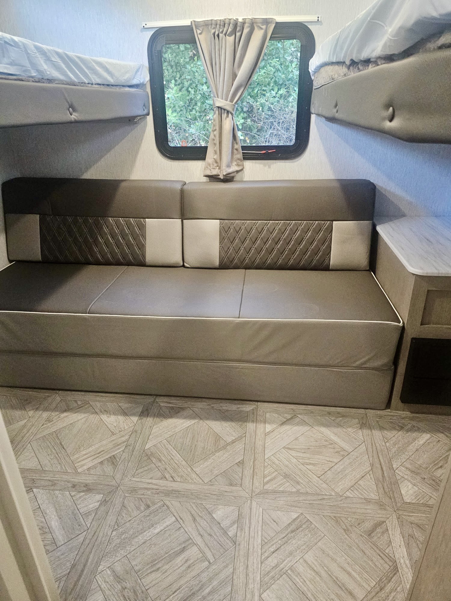 Inside an RV rental: a versatile sofa bed, bunk beds, and a window for compact, comfortable travel.. SALEM CRUISE LITE PLATINUM 28VBLX 2024