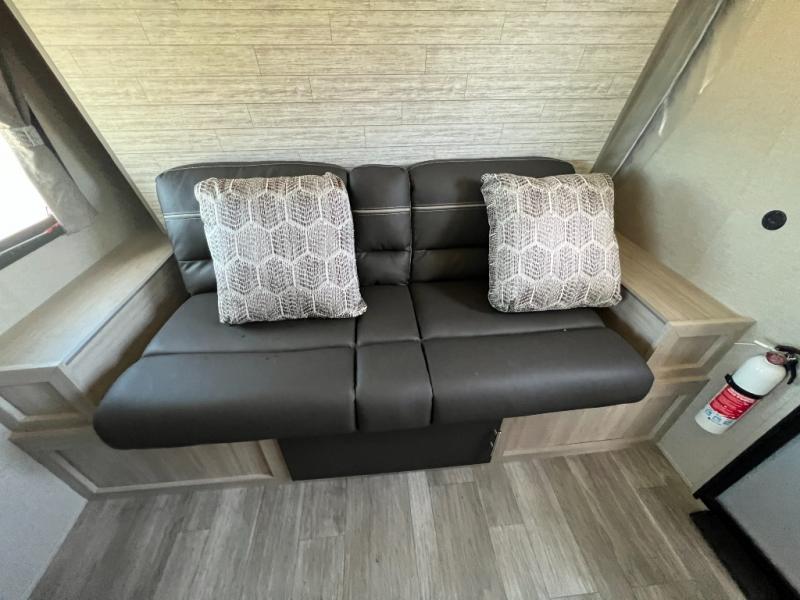 RV rental: Comfy interior with a two-person sofa, patterned pillows, and light wood accents. Fire extinguisher too.. Forest River Coachmen Catalina Summit 2022