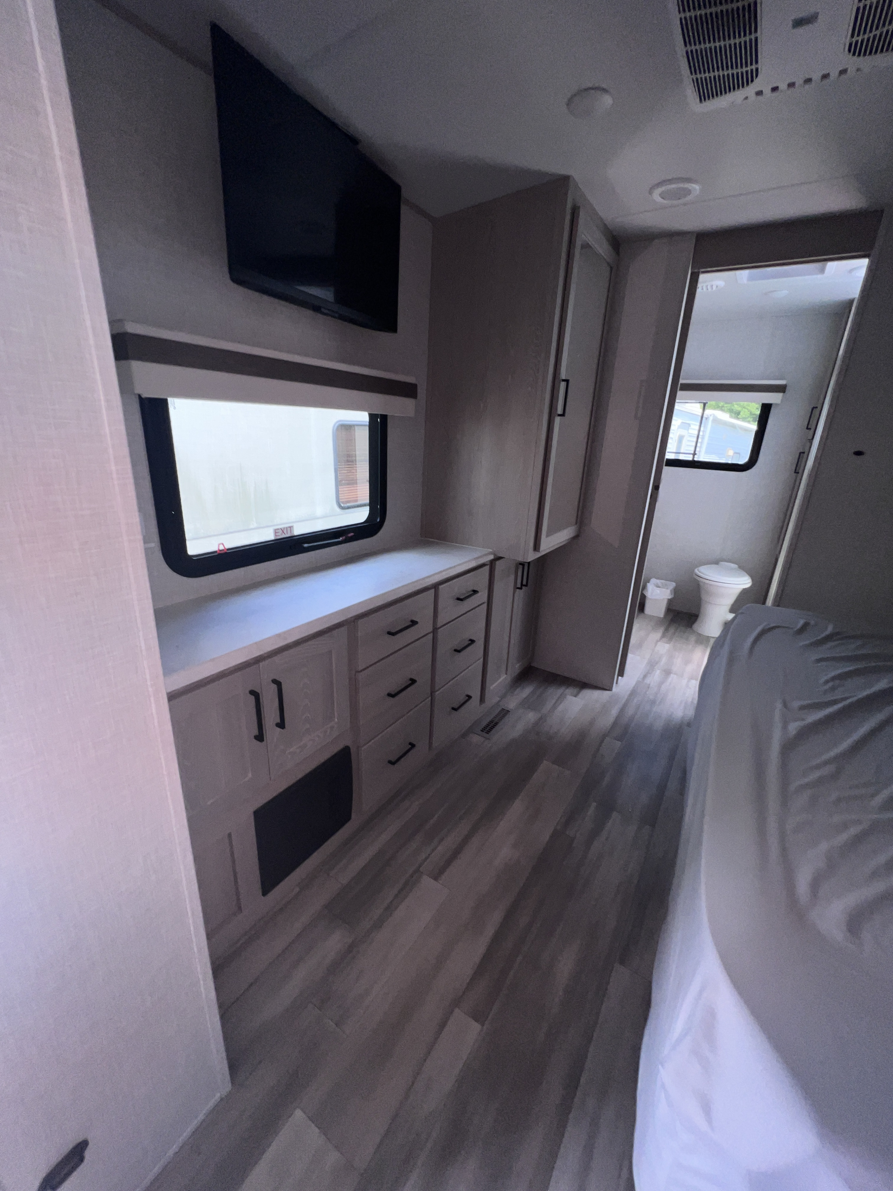 This RV rental features a well-appointed bedroom with a TV, extensive storage, and a separate bathroom.. Forest River Rockwood Signature 2022