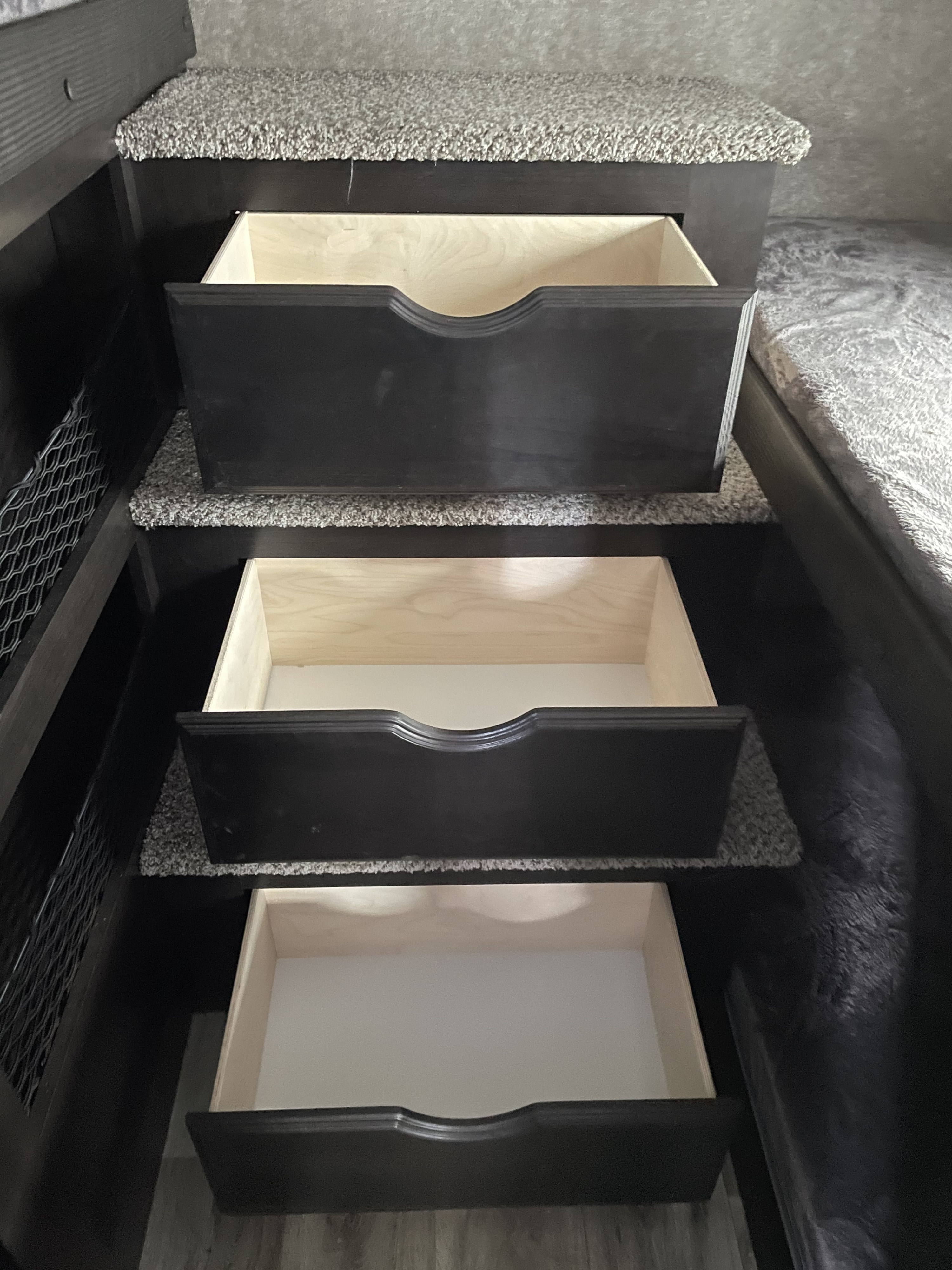 Spacious RV rental storage: Three deep pull-out drawers integrated into carpeted steps for smart organization.. Jayco Eagle HT 2021