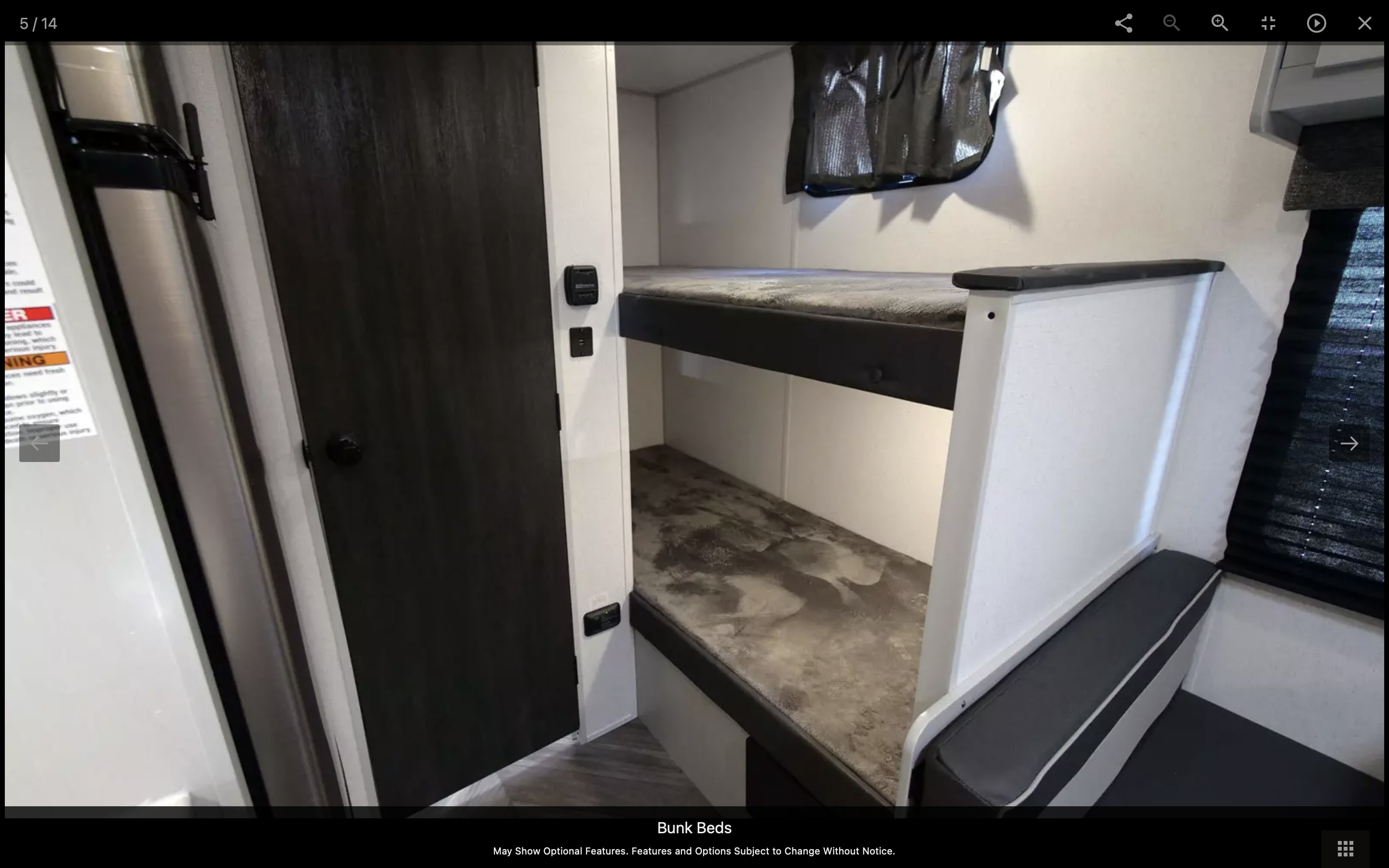 This RV rental interior features comfortable bunk beds and window blinds, providing a practical sleeping solution for trips.. Forest River Wildwood FSX 2023
