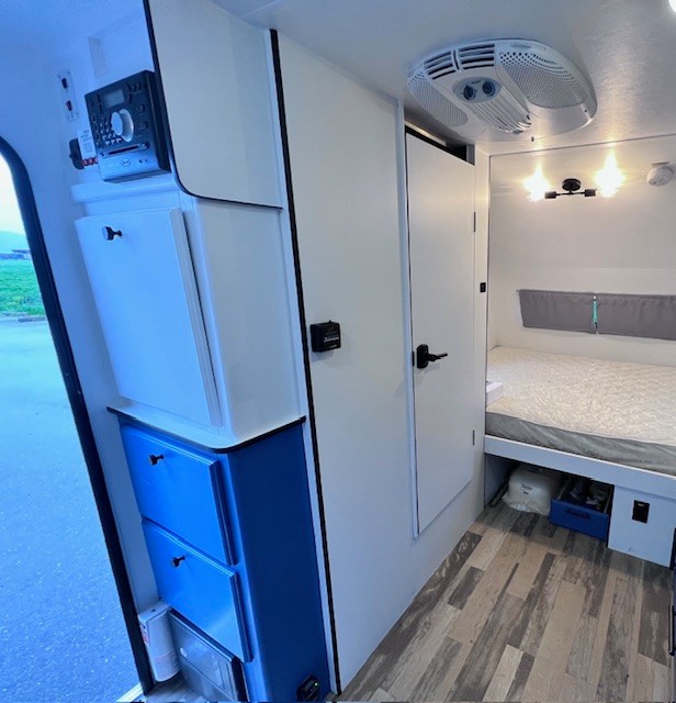 RV rental interior showcasing a bedroom, efficient storage, and entertainment system. Ready for your trip!. Winnie Drop Winnie Drop Trailer 2017
