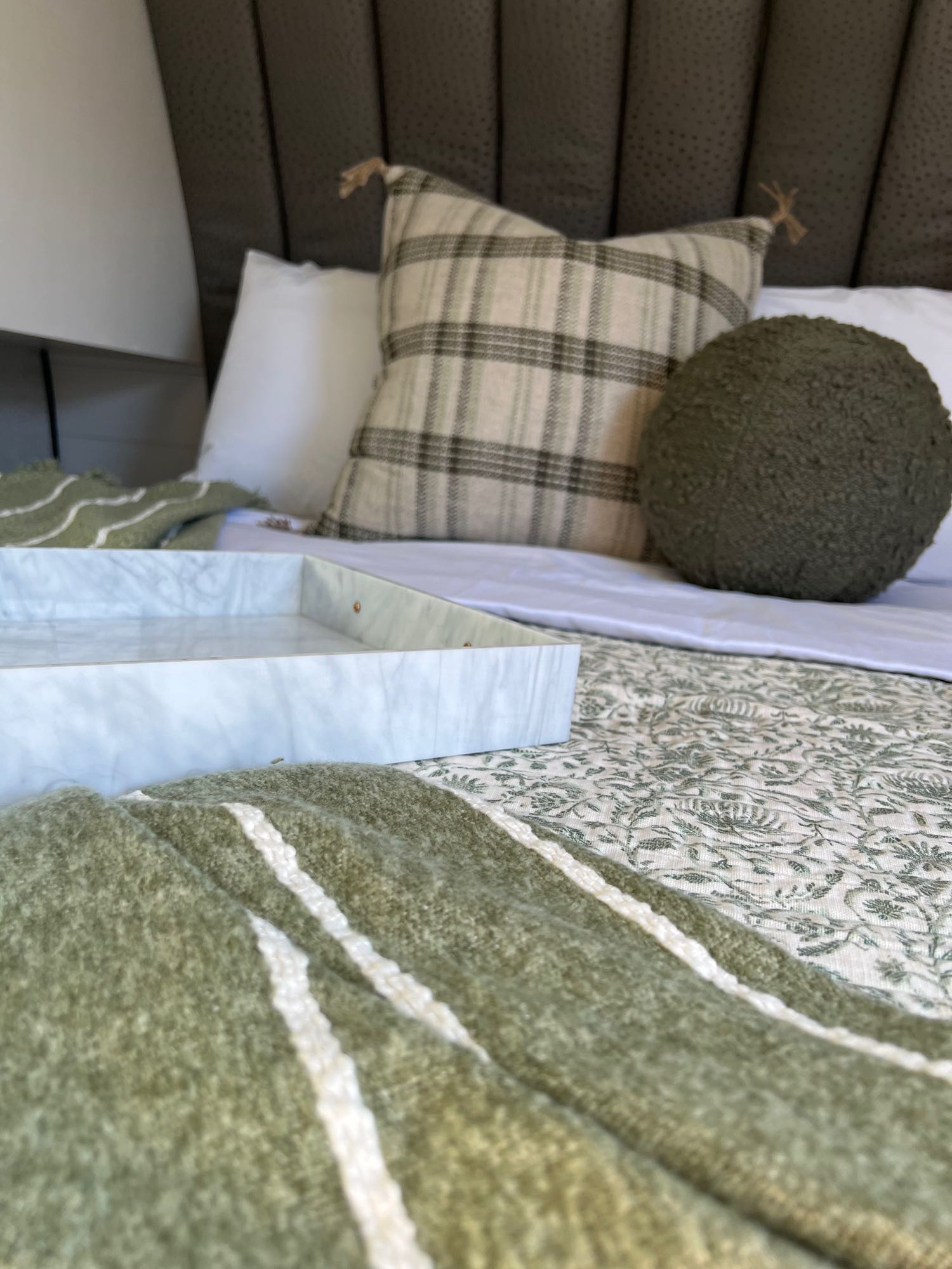 Experience home-like comfort in your rv rental: cozy bed with plaid & green pillows, soft blankets, and a chic tray.. Jayco 224BHW 2024