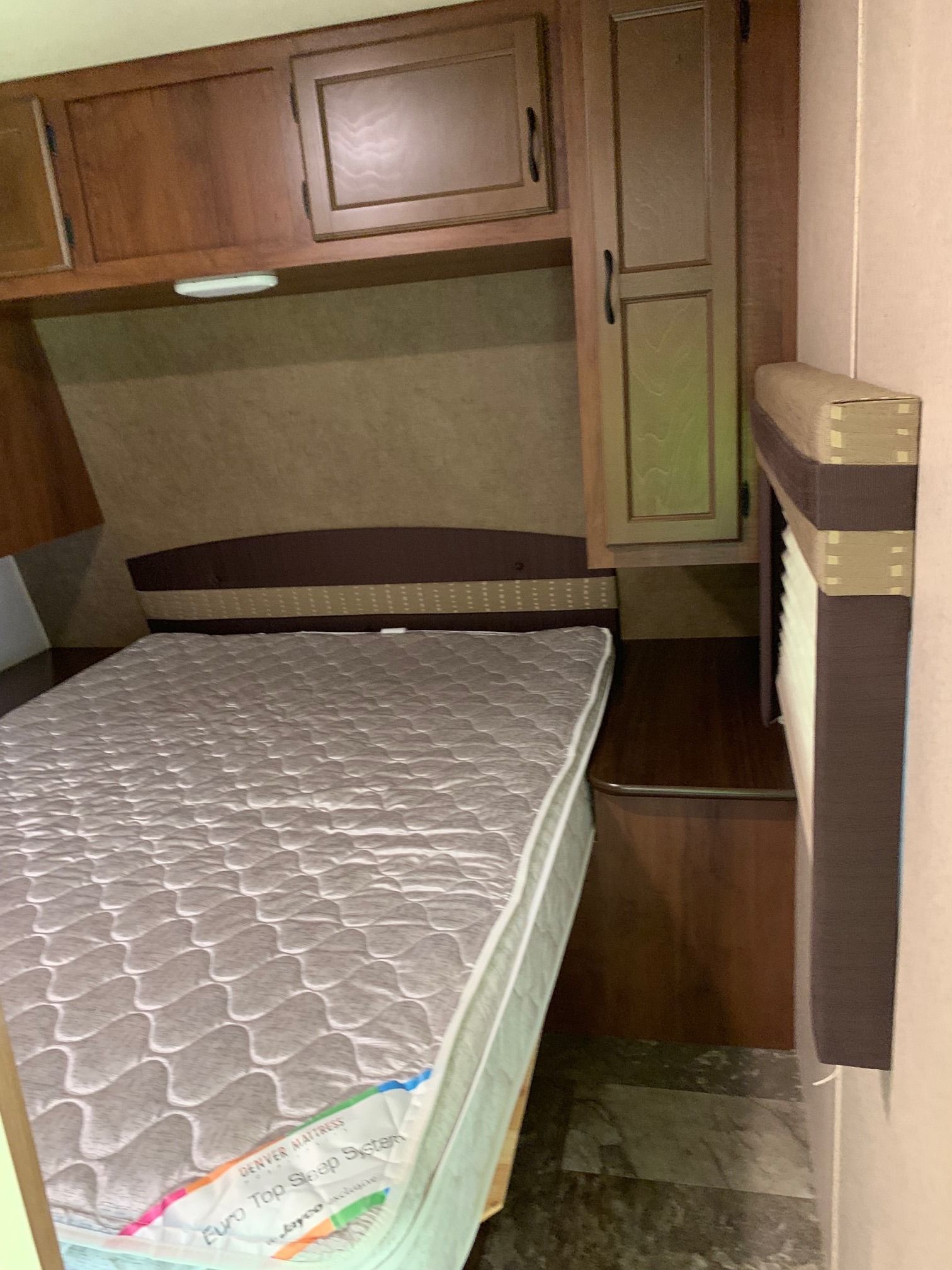 Inside an RV rental: a cozy bedroom featuring a Denver Mattress Euro Top bed and ample storage cabinets.. Jayco Jay Flight 2015
