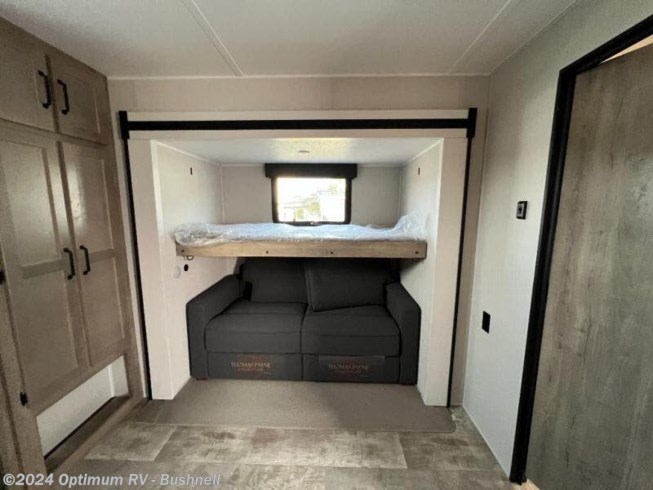 RV rental: Inside a versatile RV bunk area featuring a sofa, upper bed, and storage cabinets. Great for family trips.. Forest River Palomino Puma 2022