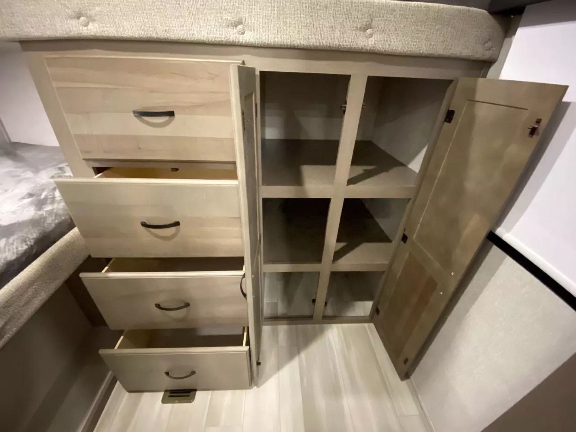 RV rental: Practical light wood storage with drawers and open shelves inside a modern camper's organized interior.. Forest River Coachmen Chaparral Lite 2022