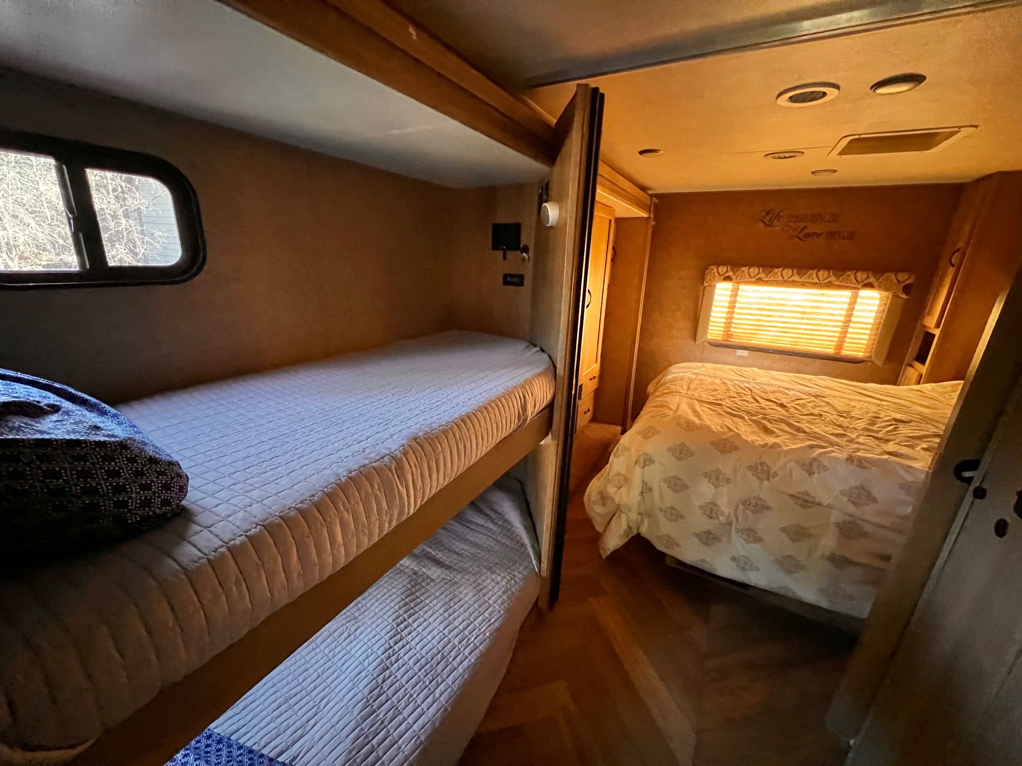 RV rental interior: bunk beds on the left, and a private master bed section on the right.. Coachmen Freelander 32BH 2016