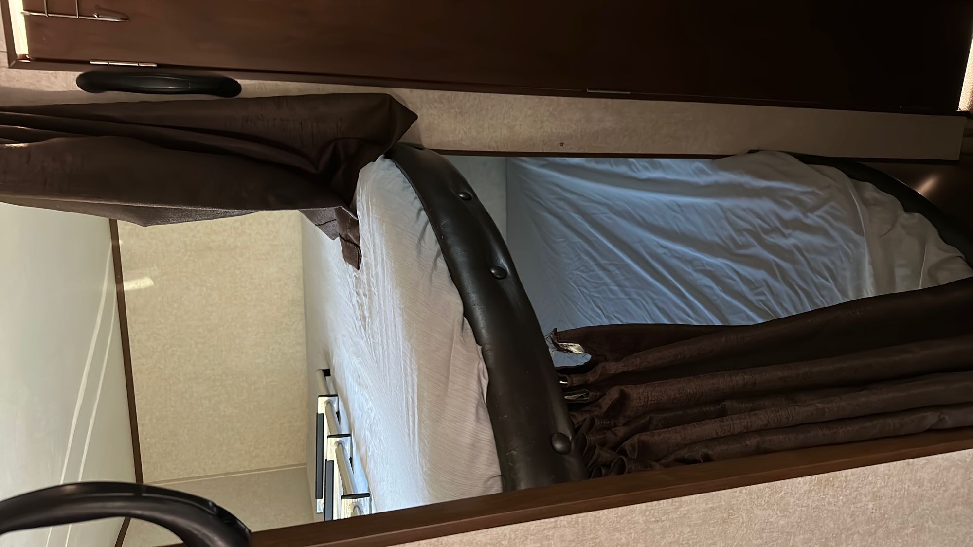 This RV rental's sleeping area features a cozy bunk bed with soft sheets, dark curtains, and a sturdy ladder.. Jayco Jay Flight SLX BHSW 2017