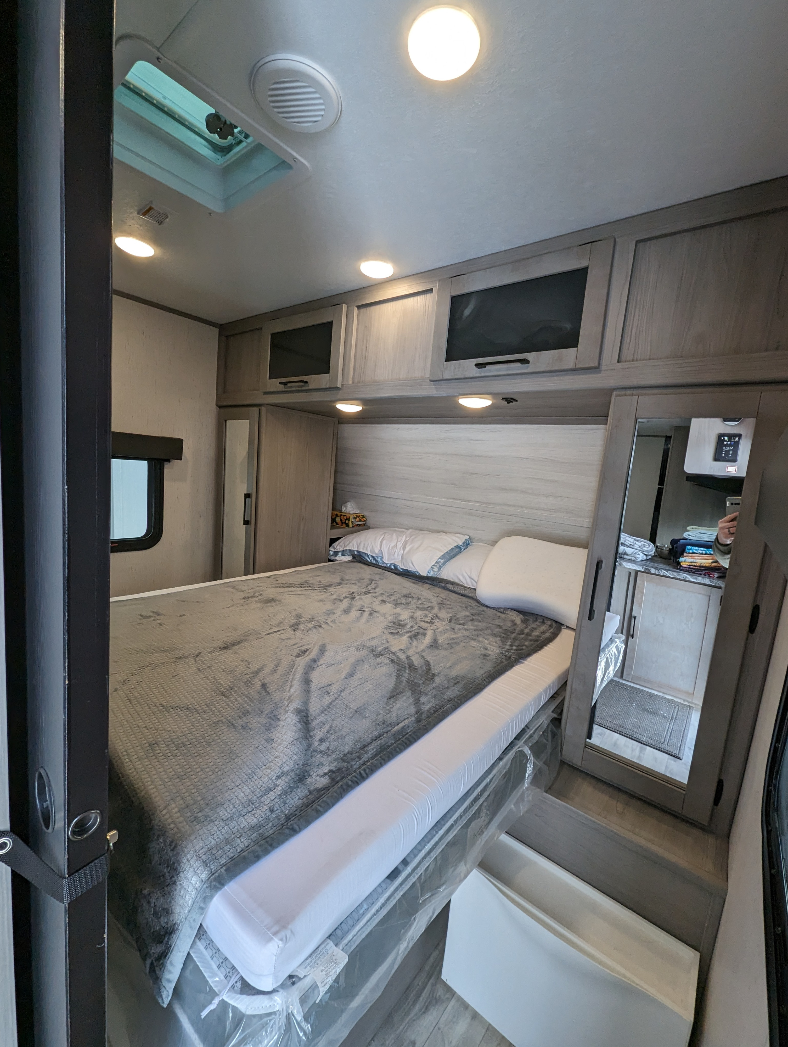 Modern RV rental bedroom with a comfy bed, sleek cabinets, and bright lighting, perfect for your next adventure.. Dutchmen Kodiak Ultra Lite 2023