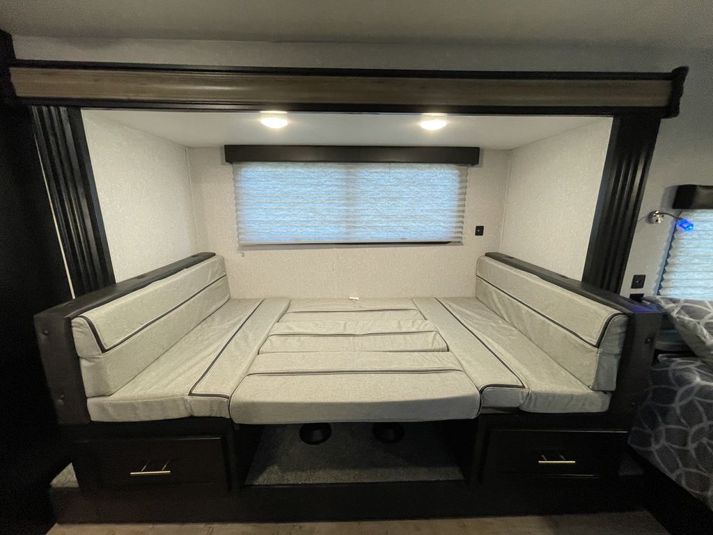 RV rental dinette converts to a bed with storage, ideal for flexible seating and sleeping in your camper.. Forest River Wolf Pup 2023