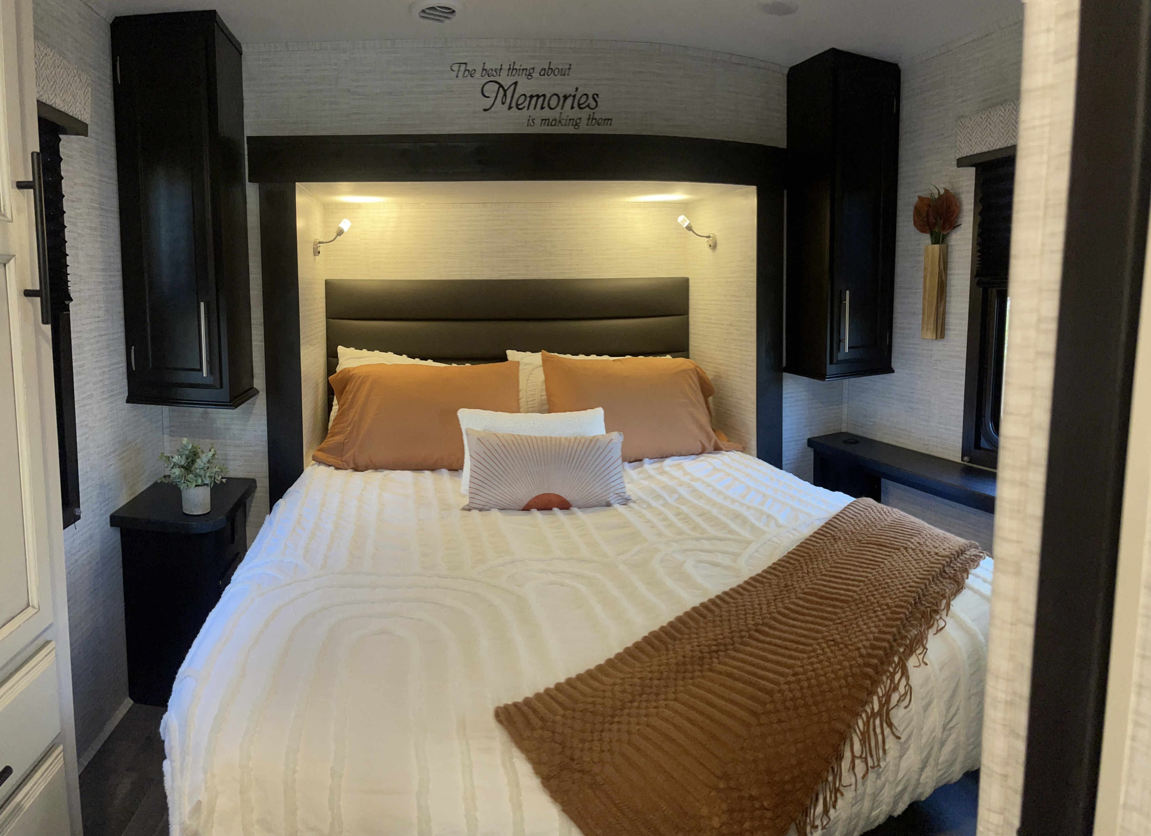 Experience comfort in this RV rental bedroom. Features a cozy bed, built-in storage, and a decorative "Memories" wall quote.. 1fdxe4fn1rdd19855 Entegra Odyssey 2024