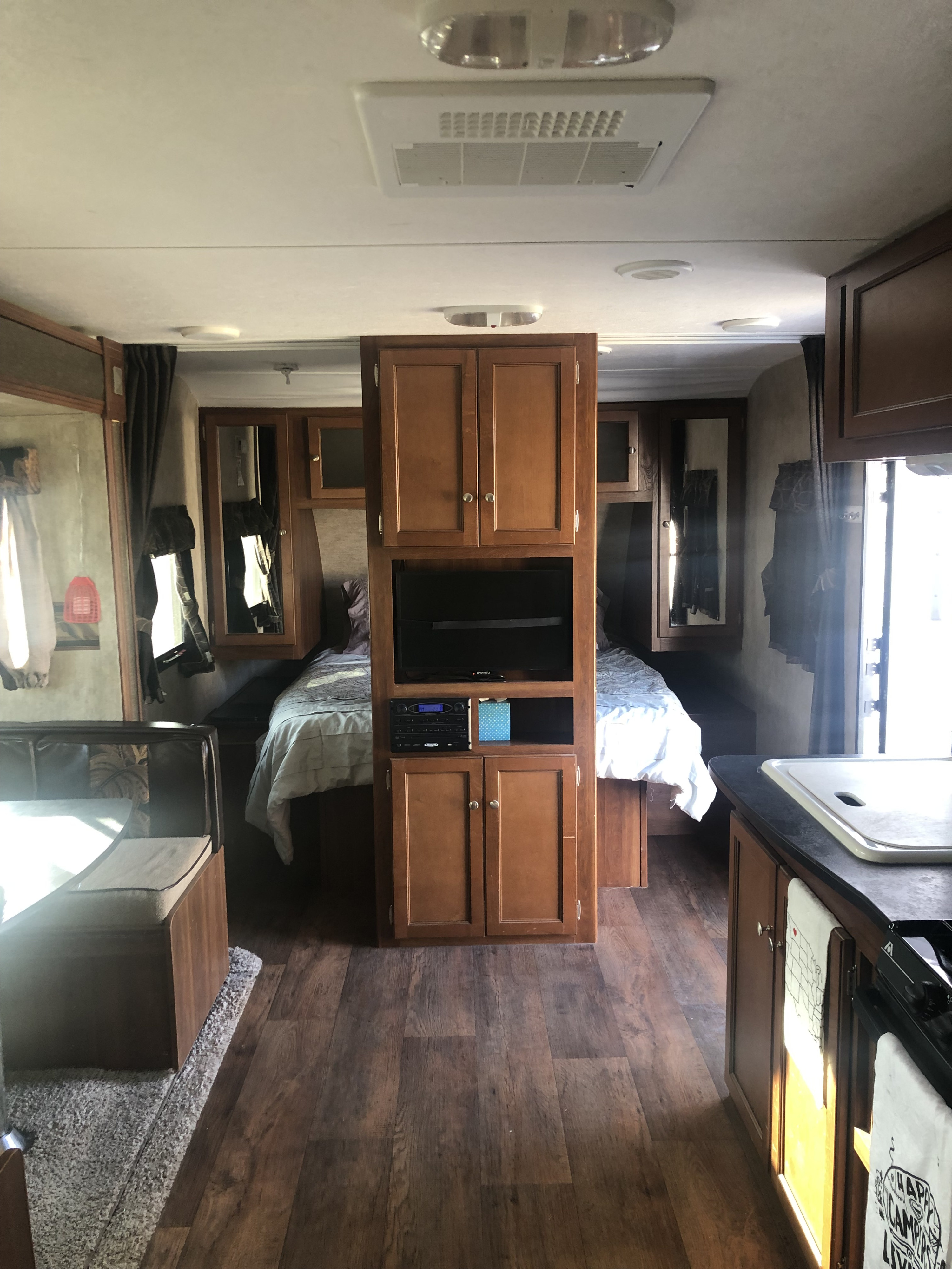 Experience comfort in this RV rental's cozy interior, featuring a bedroom, dinette, and well-equipped kitchen.. Keystone RV Bullet Ultra Lite 2015