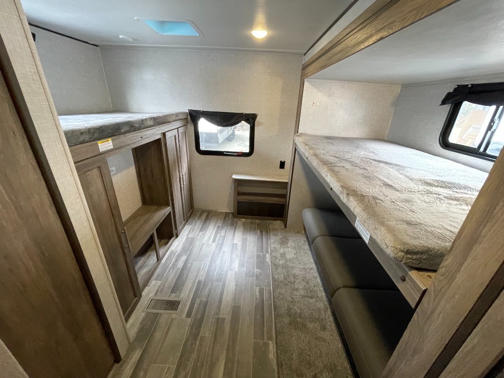 Spacious RV rental bunkhouse with multiple bunk beds, ideal for families.. Crossroads RV Zinger 2023