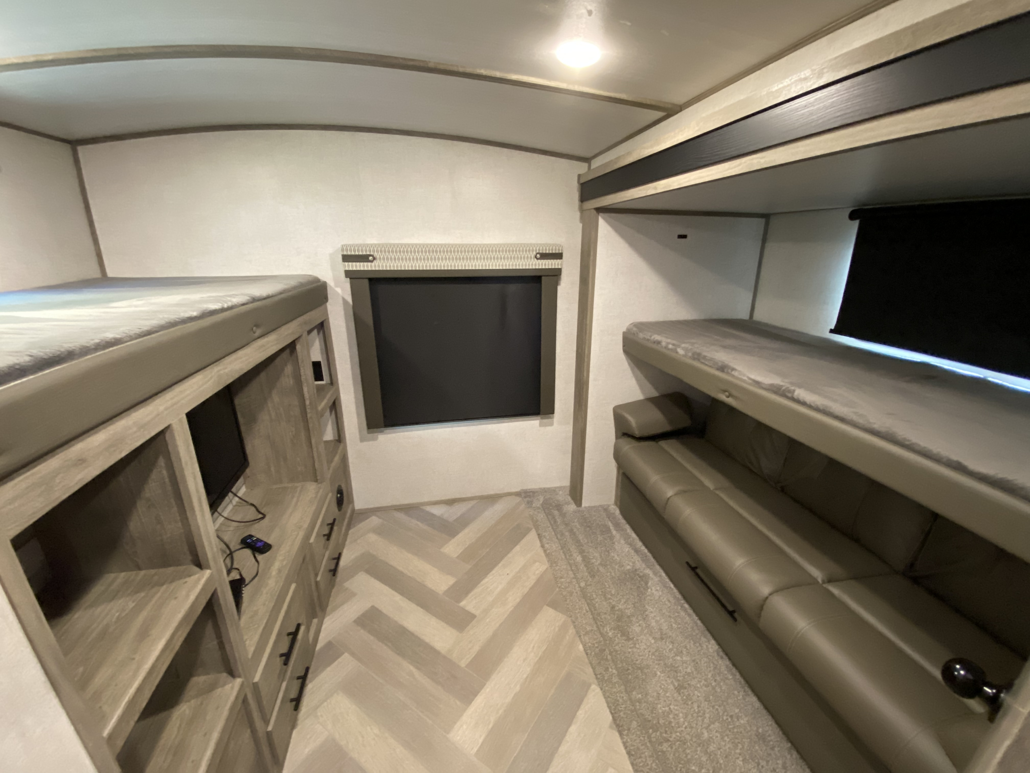 Spacious RV rental bunkroom with two bunk beds, convertible sofa, and built-in storage. Perfect for a family adventure.. Forest River Wildwood Heritage Glen 2021