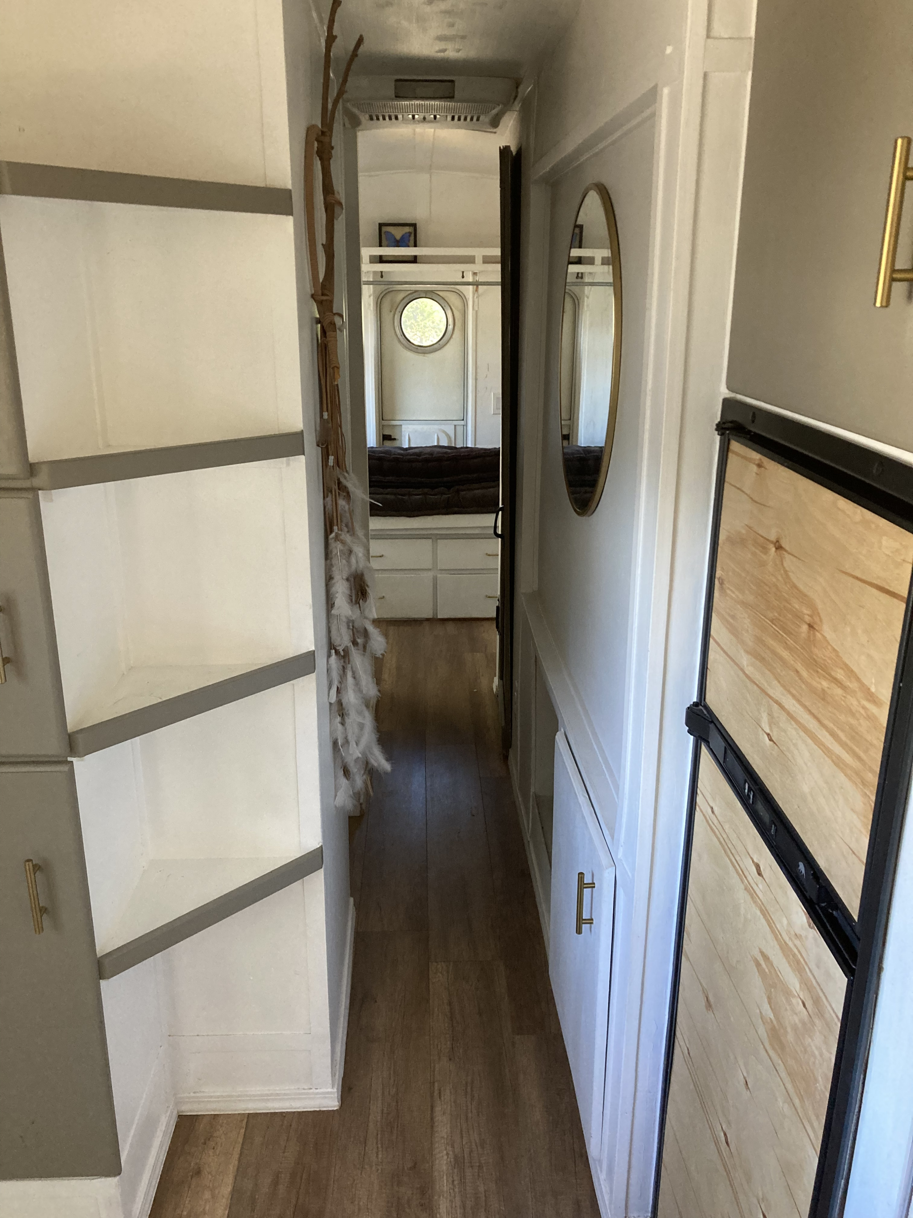 Cozy RV rental hallway with efficient storage, a mirror, and a peek into the compact bedroom. Perfect for travel.. International 3800 1995